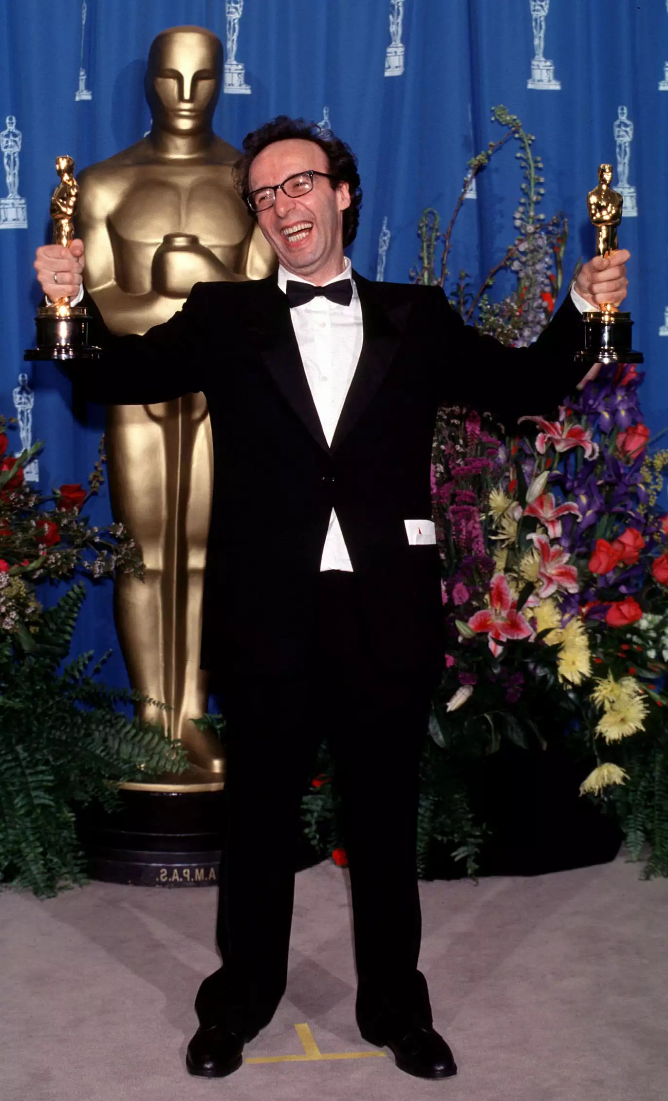 Roberto Benigni poses with two Oscars, including a trophy for Best Actor for &lsquo;Life Is Beautiful,&rsquo; in the press room at the 71st annual Academy Awards in L.A. on March 21, 1999