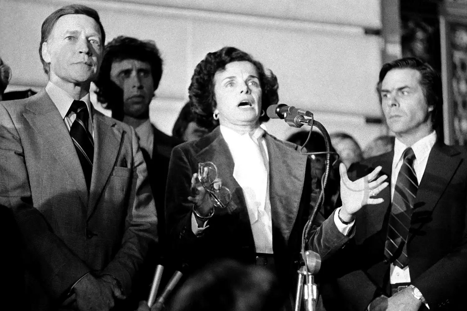 Acting Mayor Dianne Feinstein with Police Chief Charles Gain at left, addresses the more than 25,000 people jammed around San Francisco&rsquo;s City Hall, Nov. 28, 1978