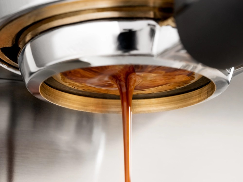 - Healthy Brew Hub A close-up photo of espresso being extracted.