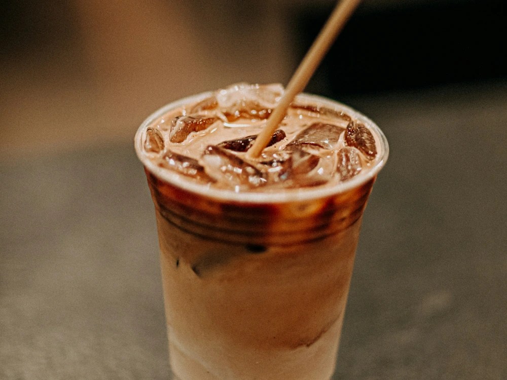 - Healthy Brew Hub Iced coffee drink with a straw.