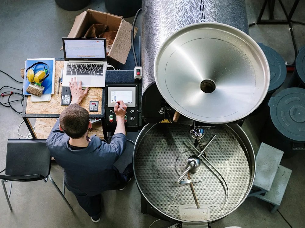 healthy brew hub a roaster sets up a large roasting machine