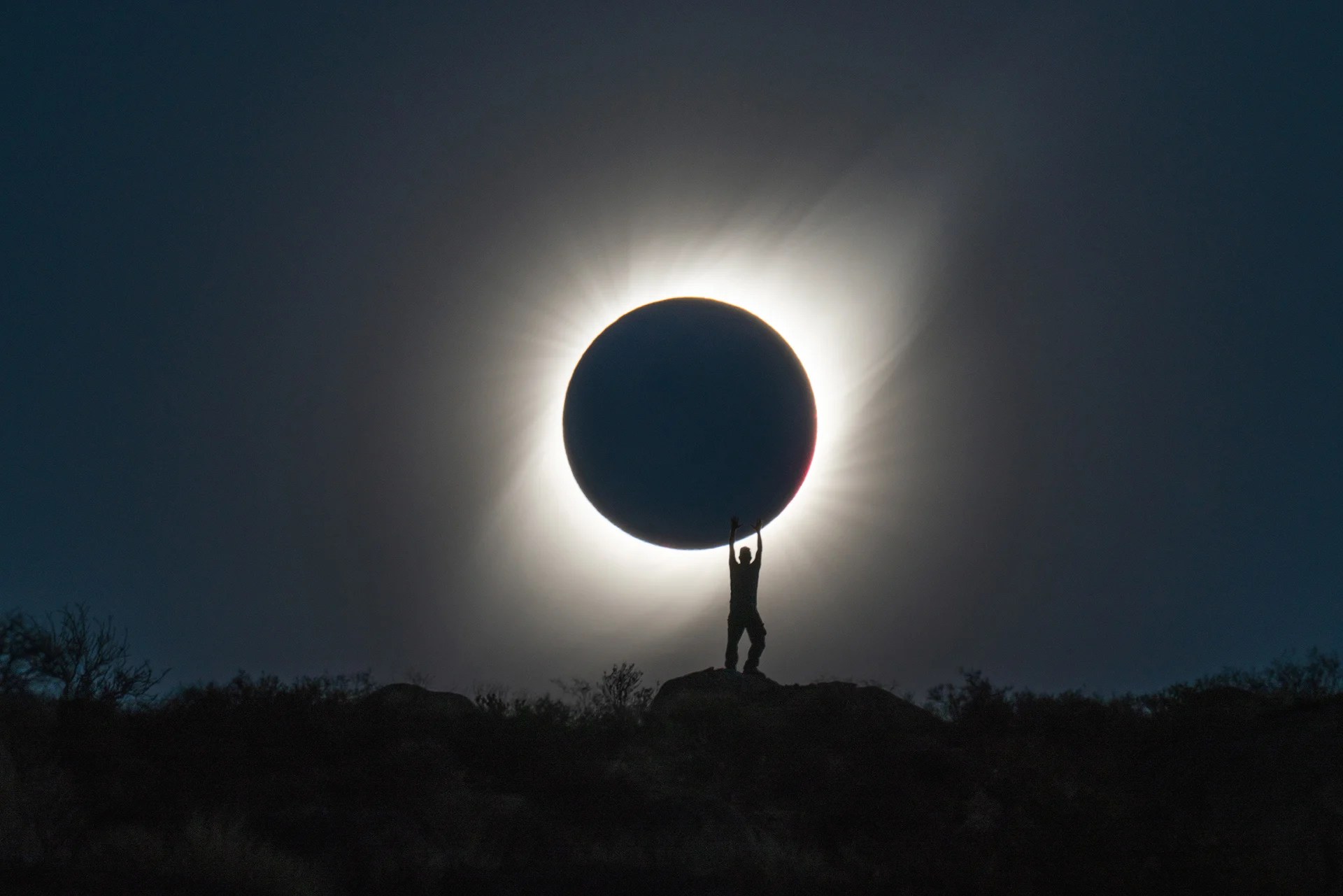 Photographer Captures Perfect Shot of Person 'Holding' the Total Solar