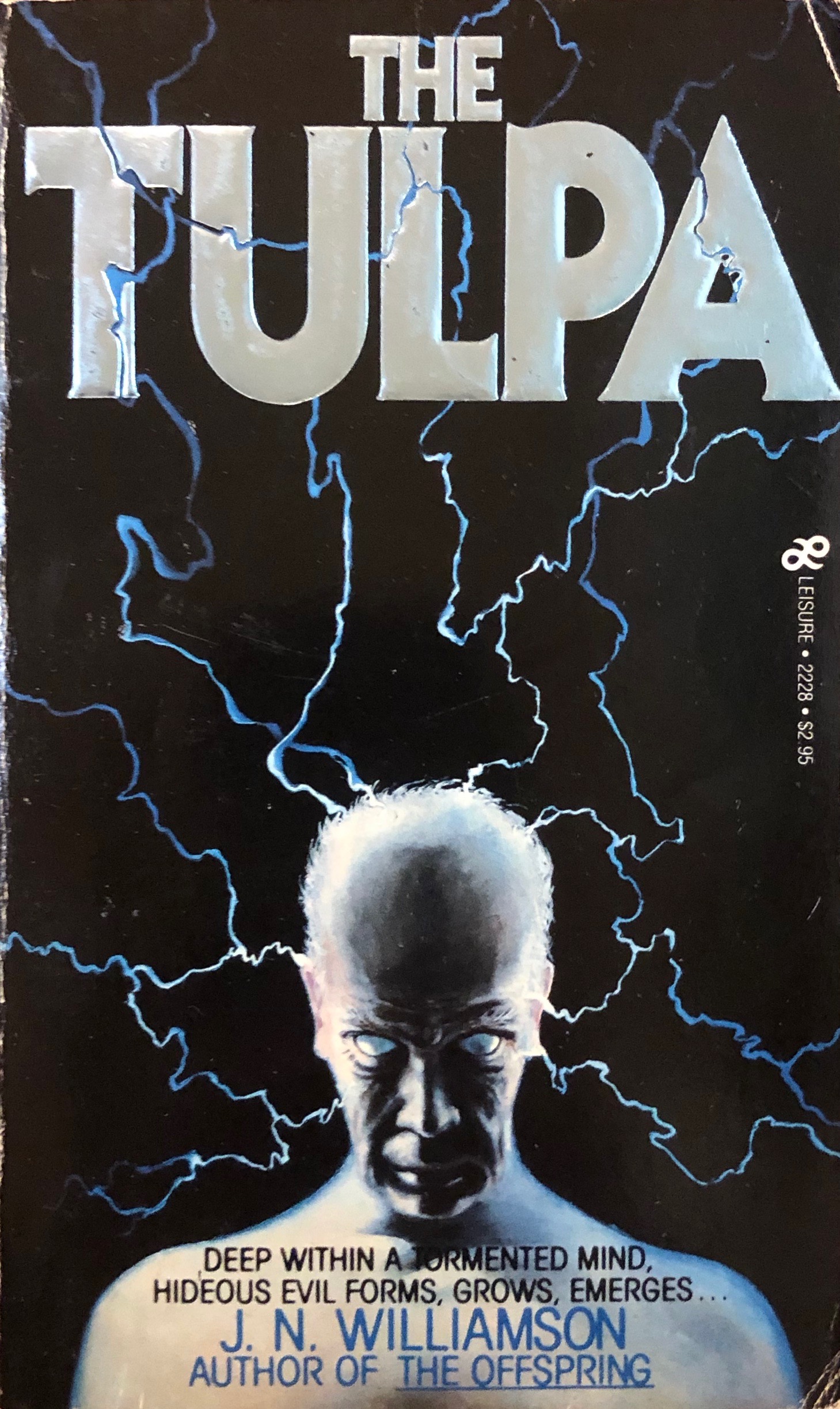 On the original cover of J. N. Williamson's "The Tulpa," an older, balding man stares, his eyes white, while lightning flashes.