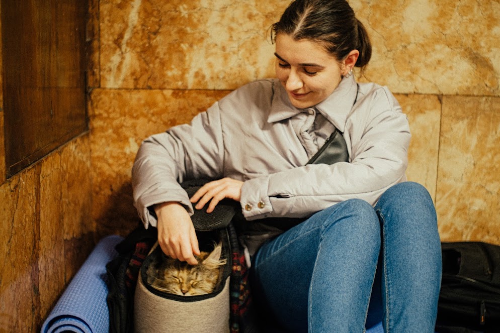 A girl with a cat in the metro PHOTOBANK