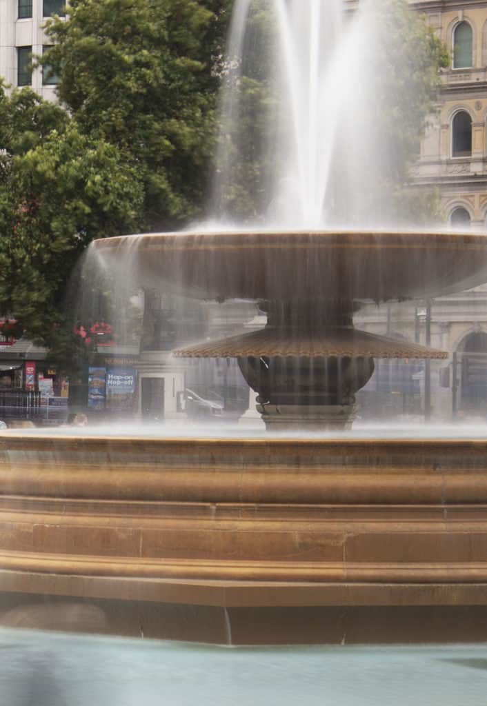 What is Shutter Speed in Photography? Trafalgar square fountain showing misty water captured with a very slow shutter speed.