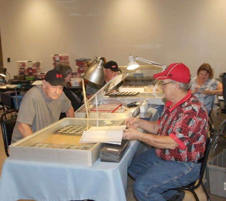 Coin show dealers looking for premium gold and silver coins