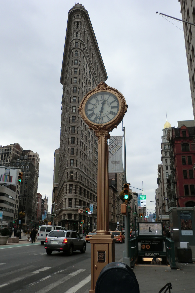 Manhattan, NY Fifth Avenue Building Clock and the Flatiron Building both landmarks of nyc