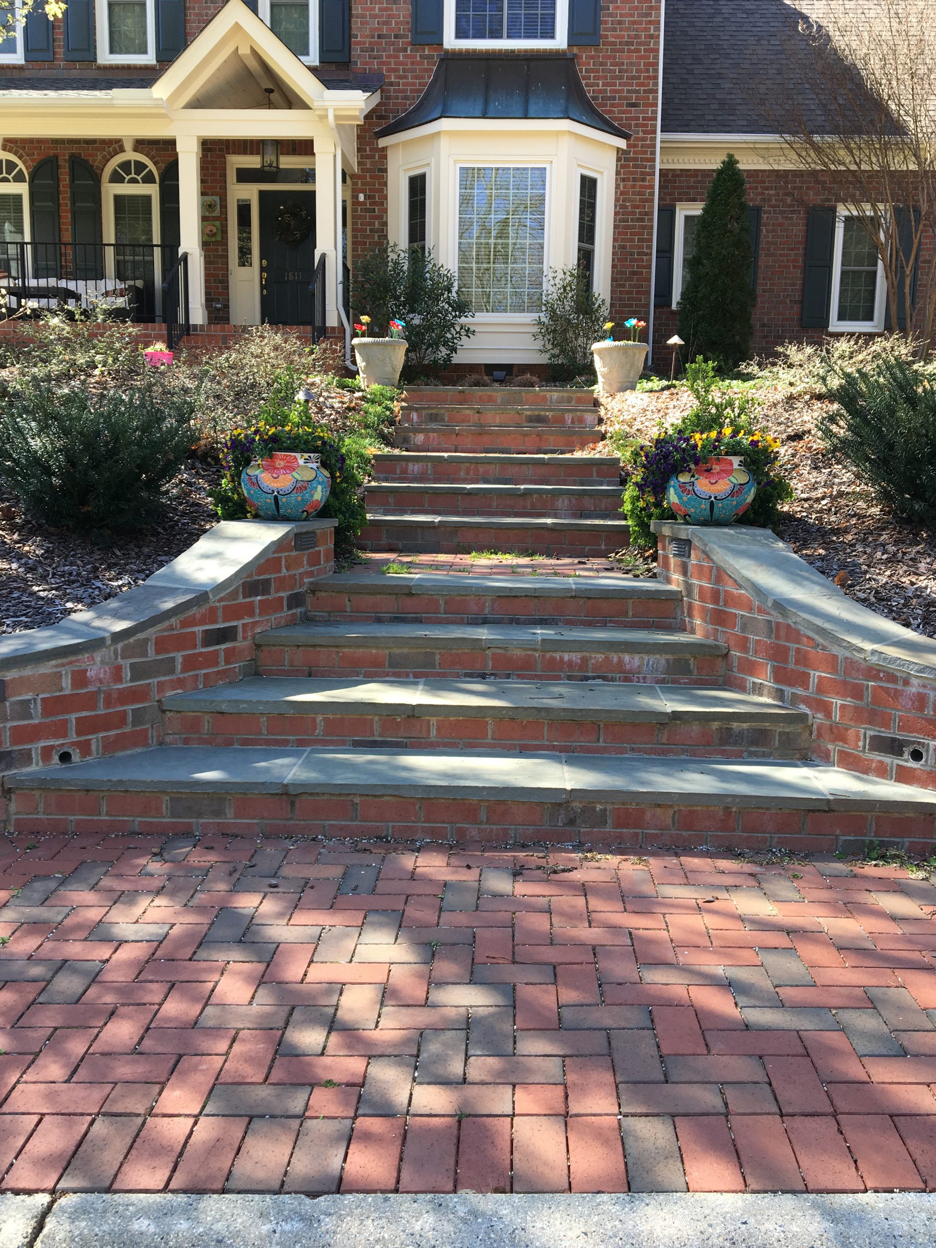 Exterior makeover with clay paver walkways, steps and drives