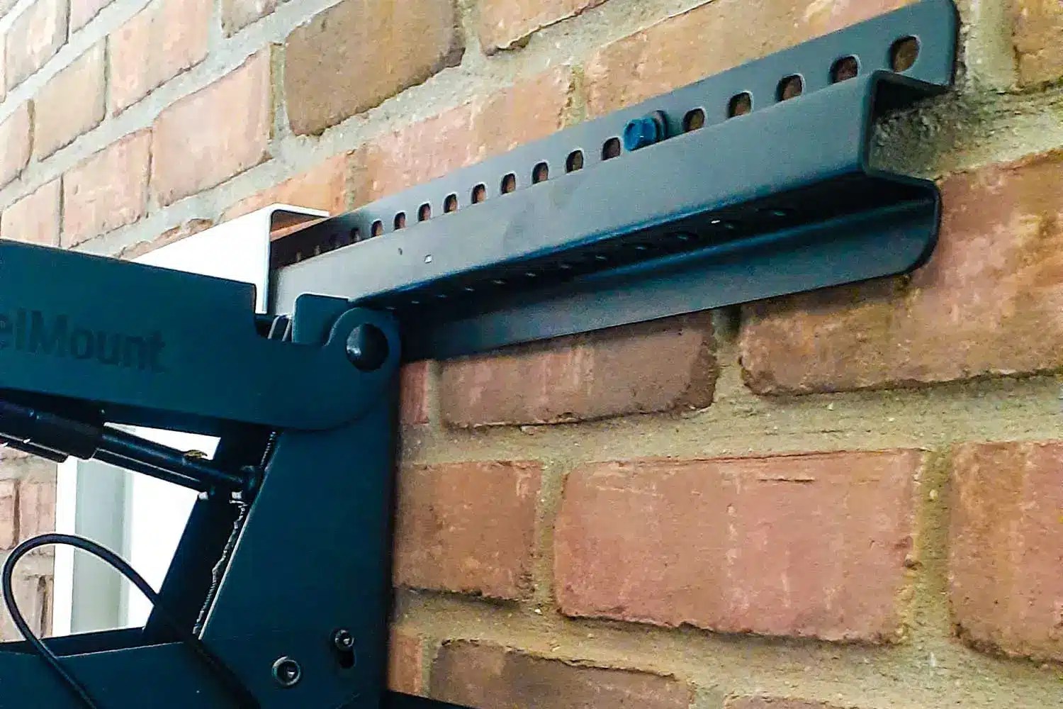 When mounting a TV on interior brick, drill into the brick, not