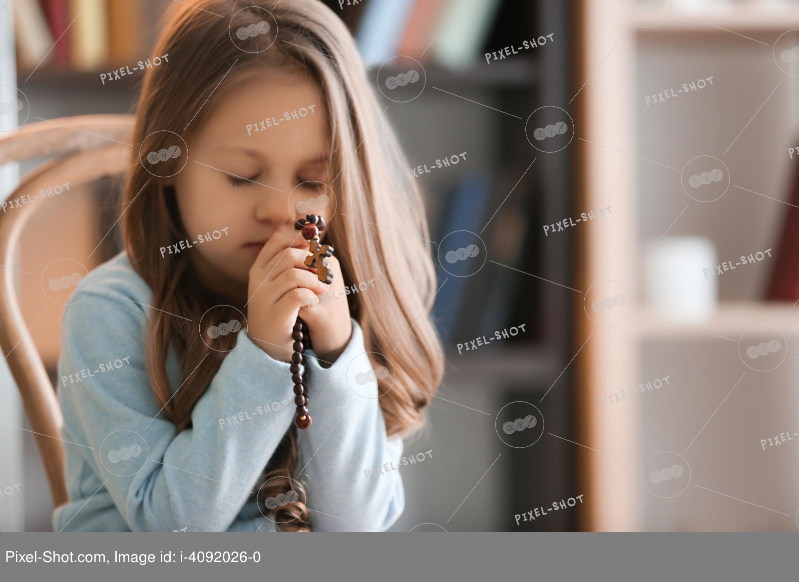 Religious Christian girl praying indoors Stock Photography Agency