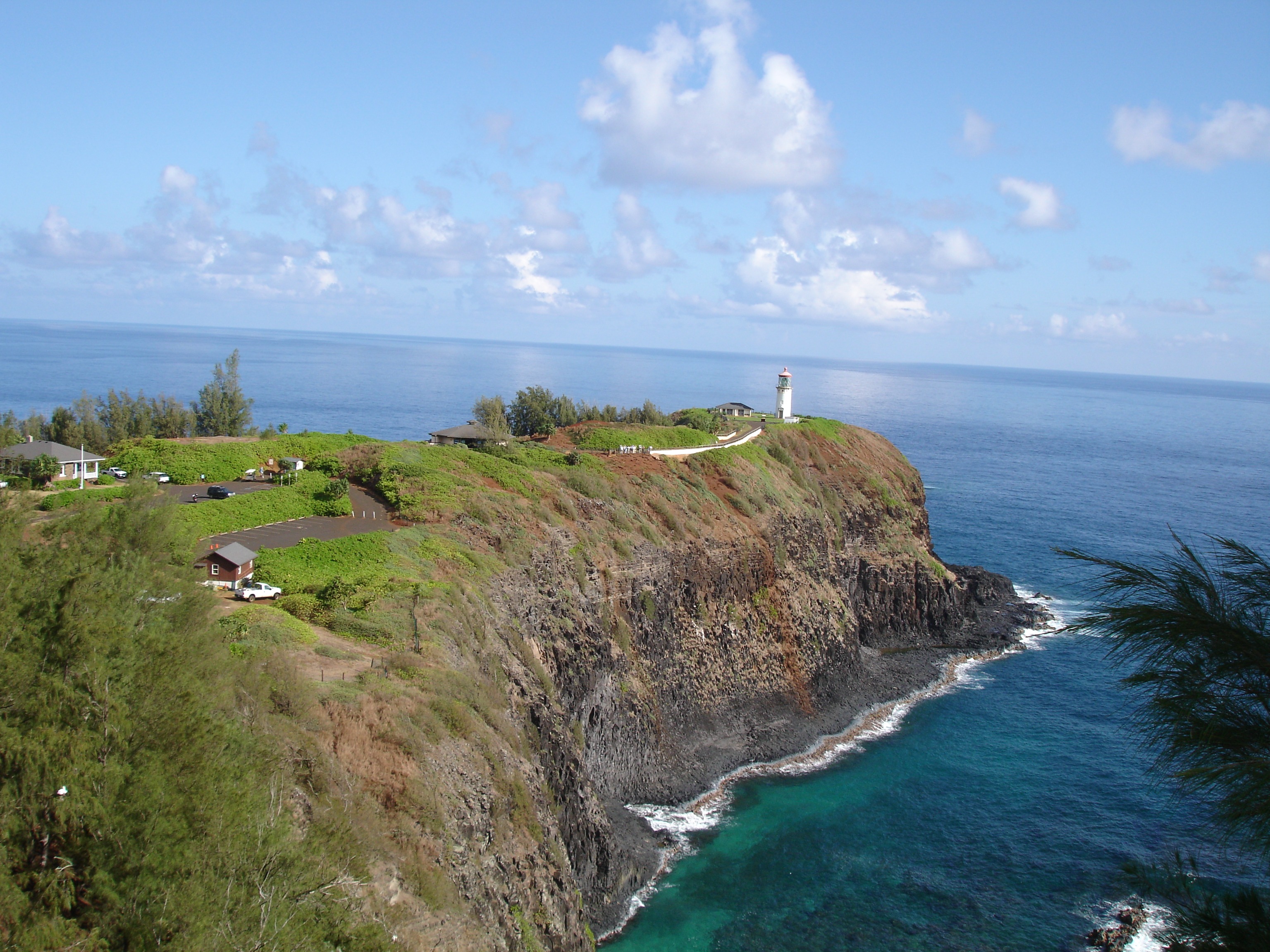 Distant view of kilauea point lighthouse on cliff at ocean, usa, hawaii