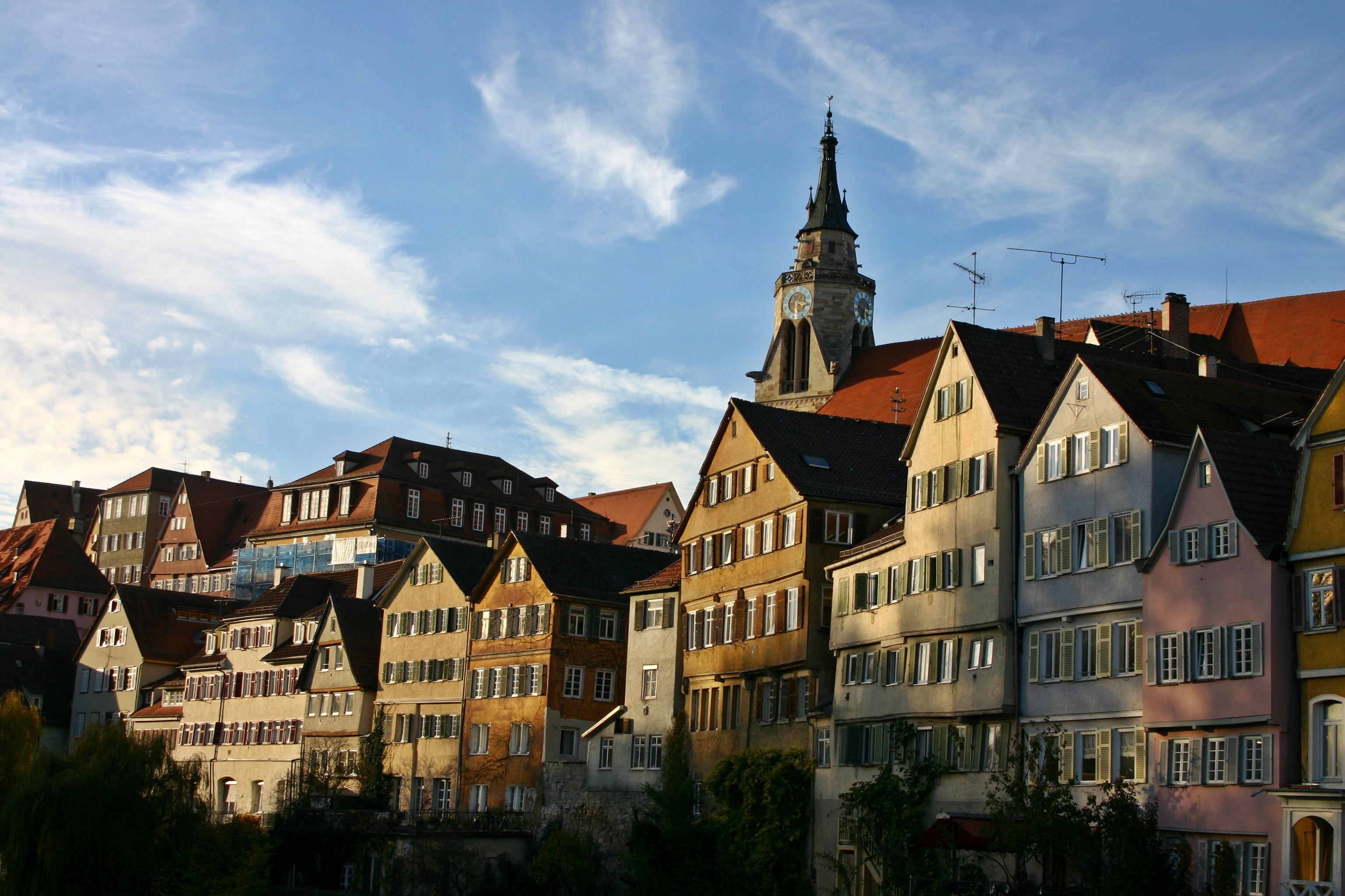 Church tower among aged houses, germany, tübingen free image download