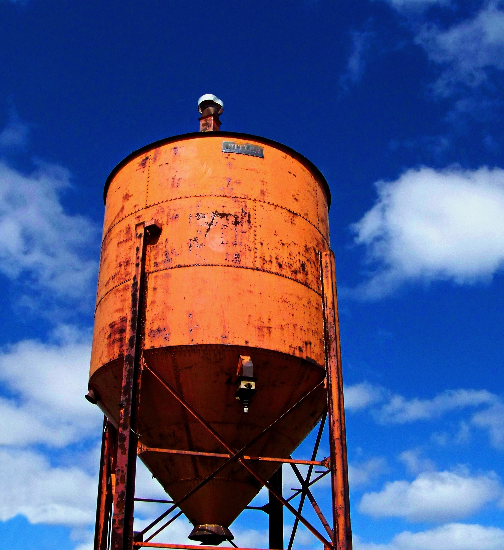 Orange water tower against blue sky free image download