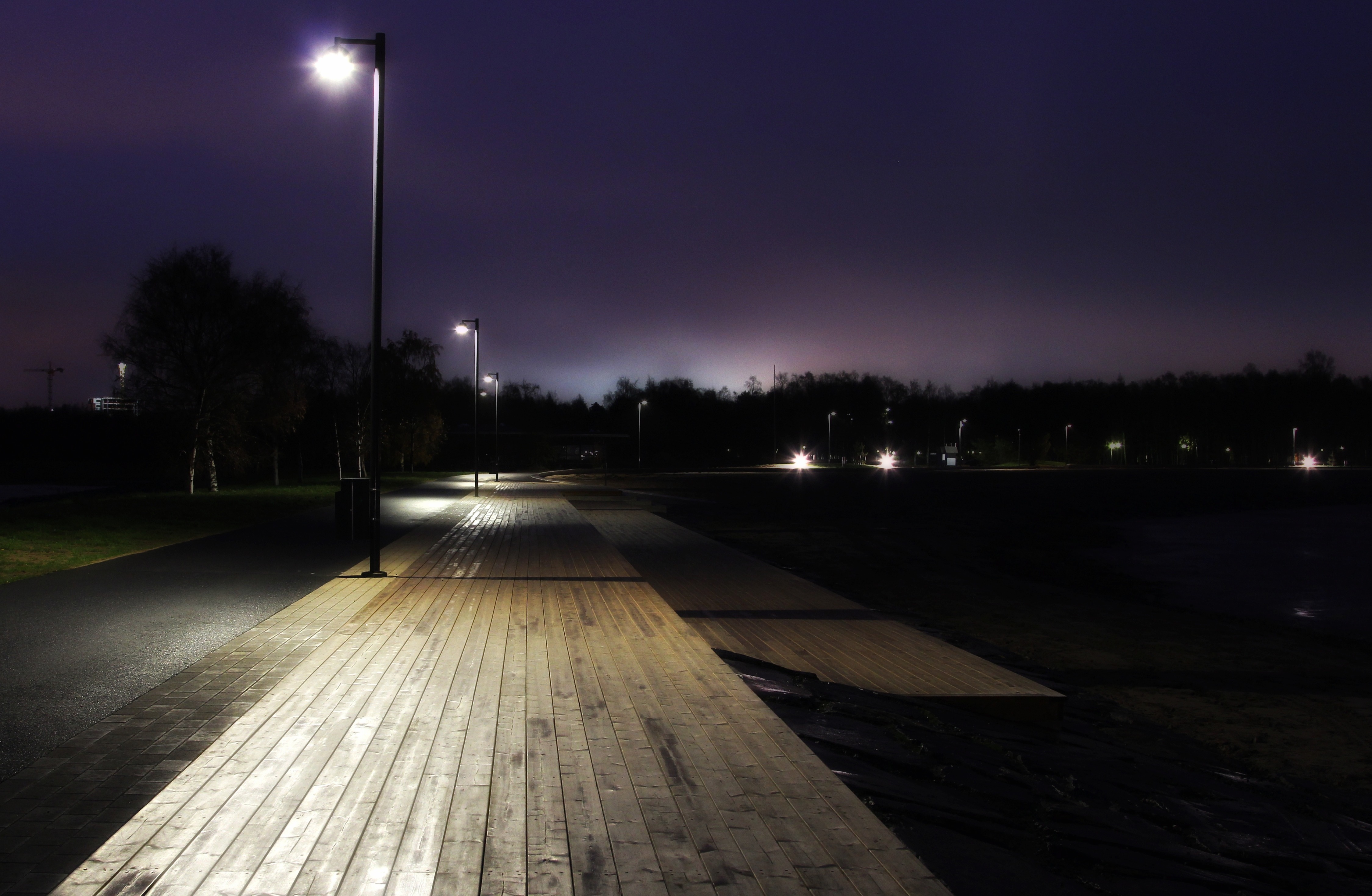 Walk on the boardwalk illuminated by night lights free image download