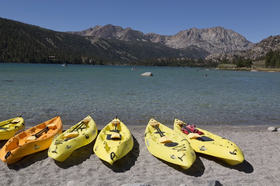 Yellow kayaks on sand beach shore lake water free image download