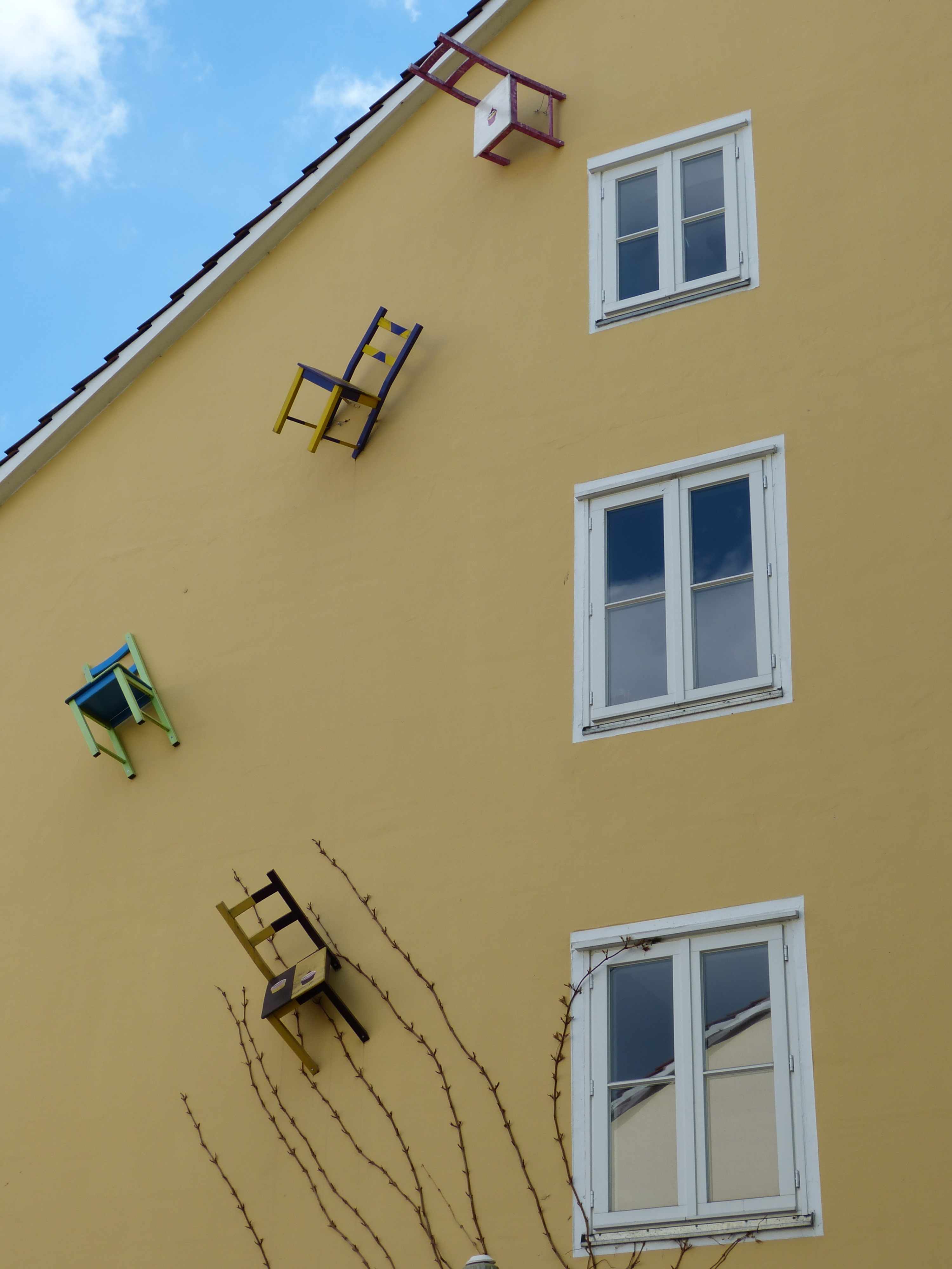 Chair sculptures on the building wall free image download