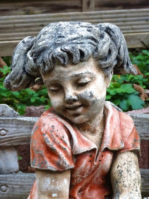 Girl stone statue in a garden free image download