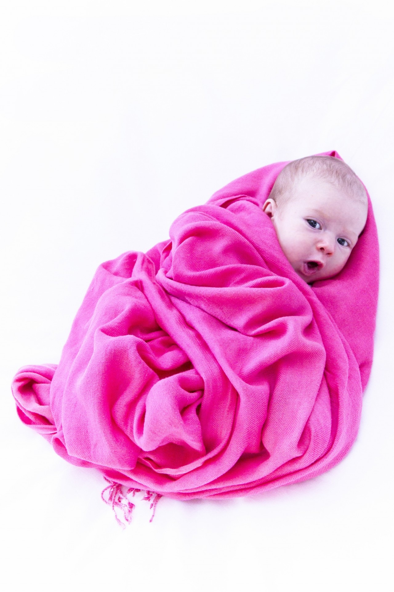 Baby wrapped in a pink blanket free image download