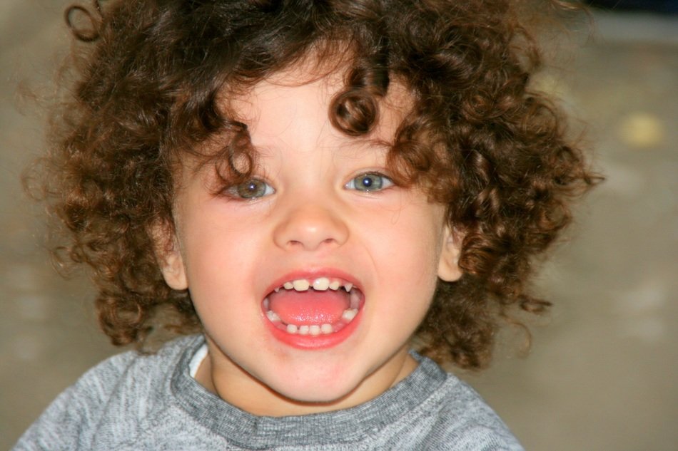 Curlyhaired child with mouth open free image