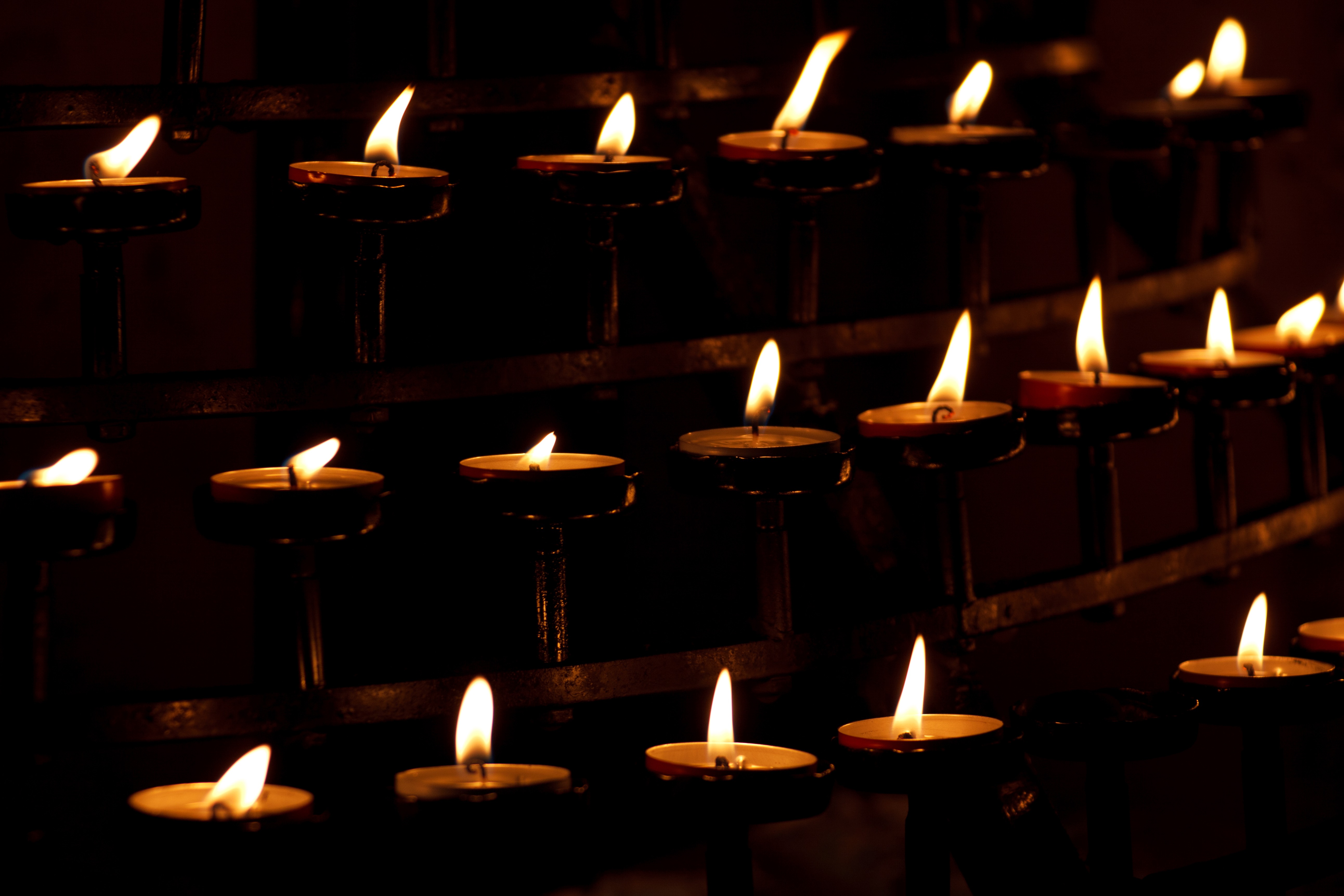Burning candles in a church in the dark free image download