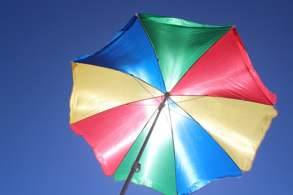Colorful sun protection parasol at blue sky free image download