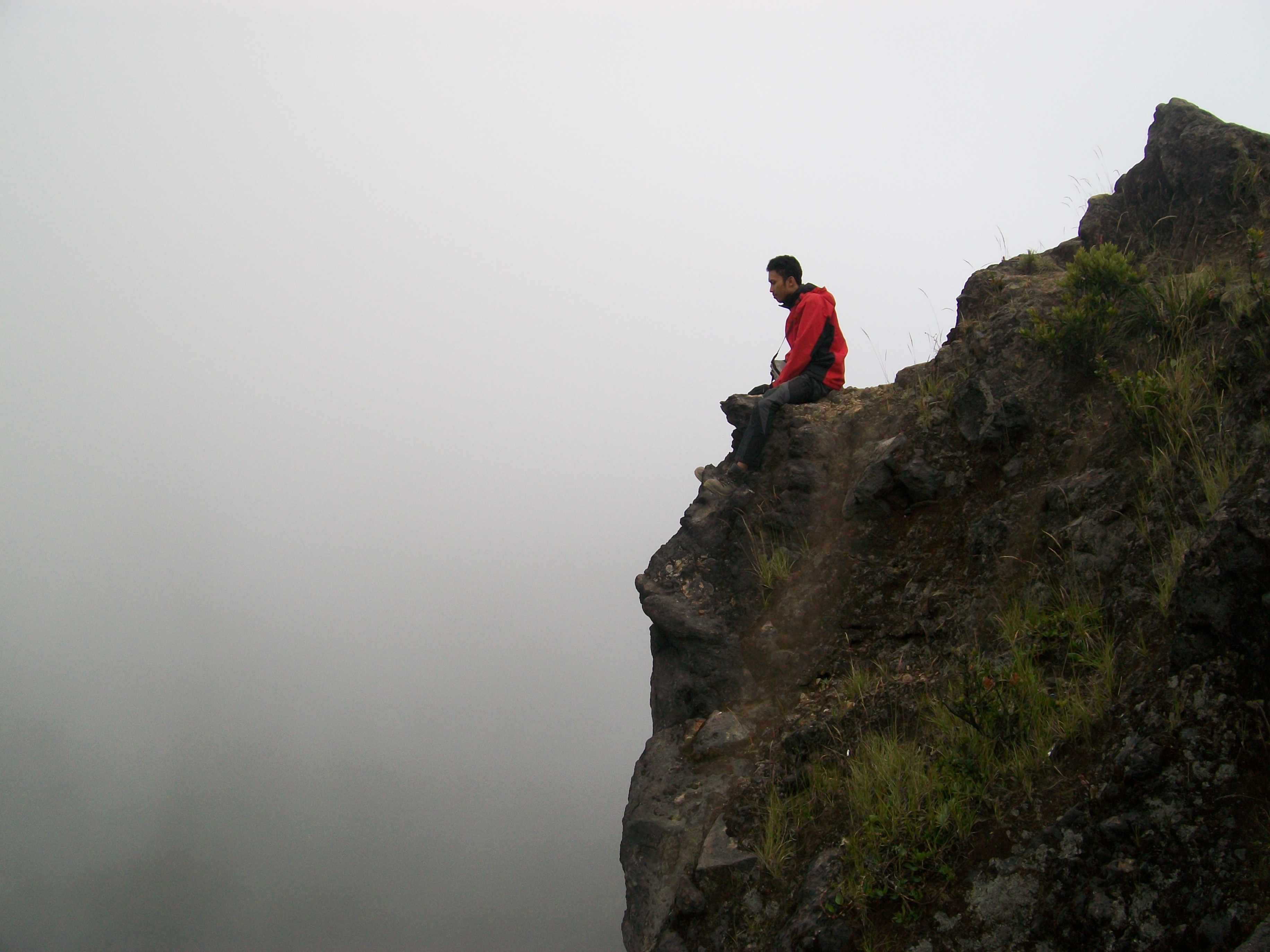 Man sitting on the cliff edge free image download