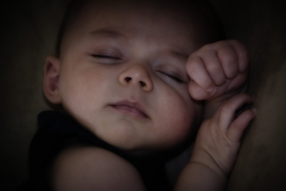 Photo of peacefully sleeping baby in her arms free image download