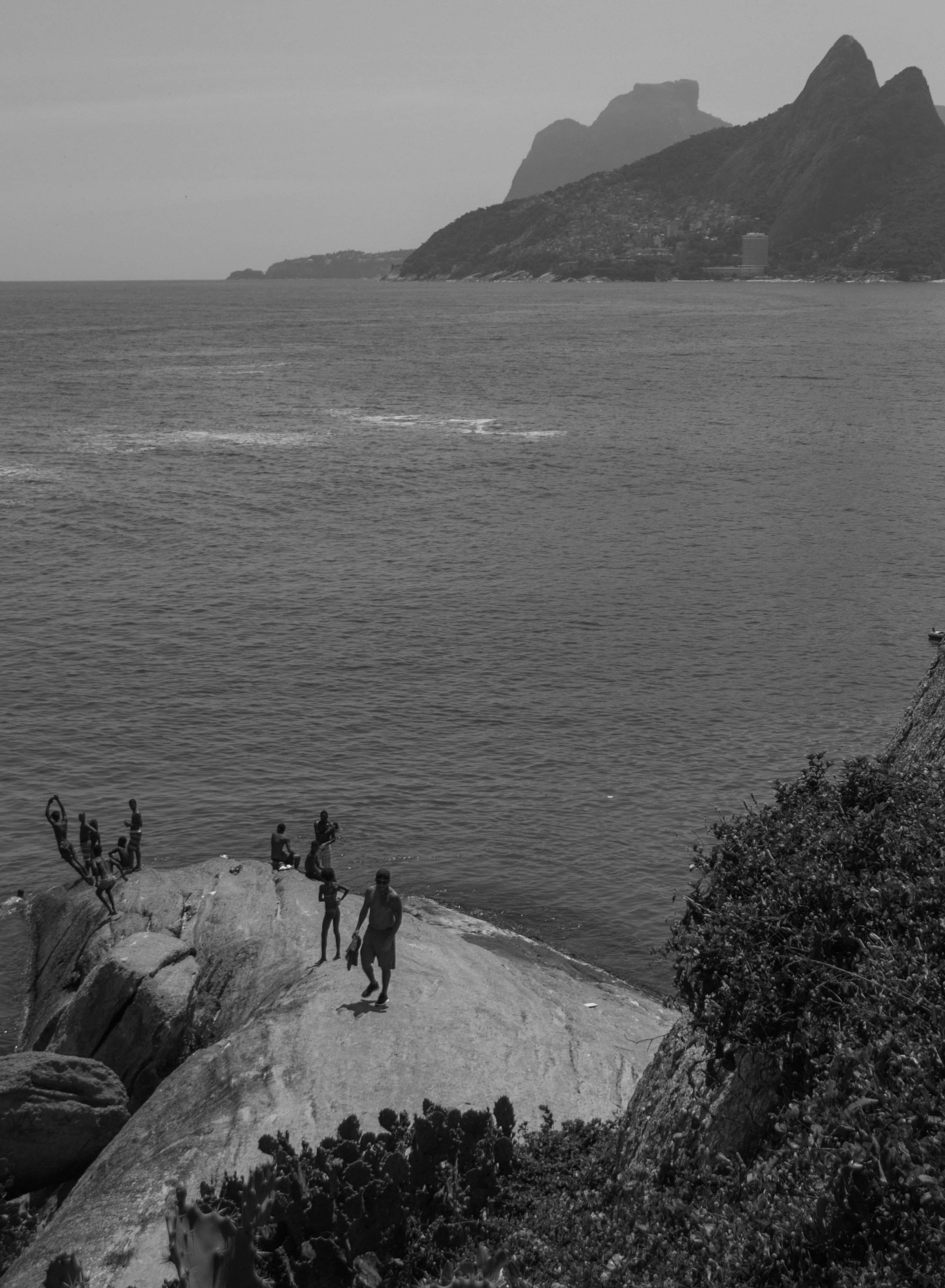 Divers on a cliff by the ocean in Rio de Janeiro free image download