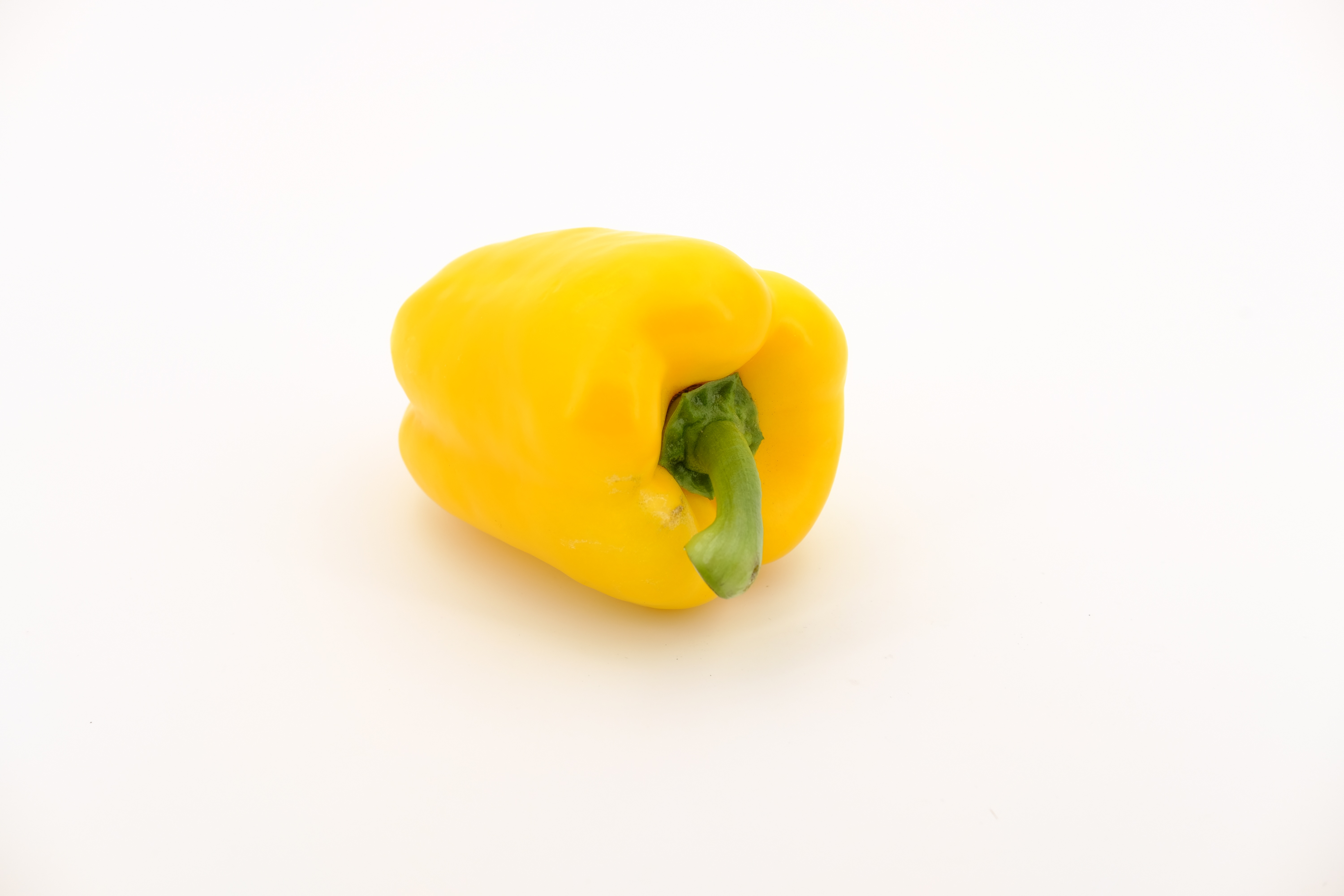 Beautiful, ripe, yellow paprika pepper, with shadow, on the white