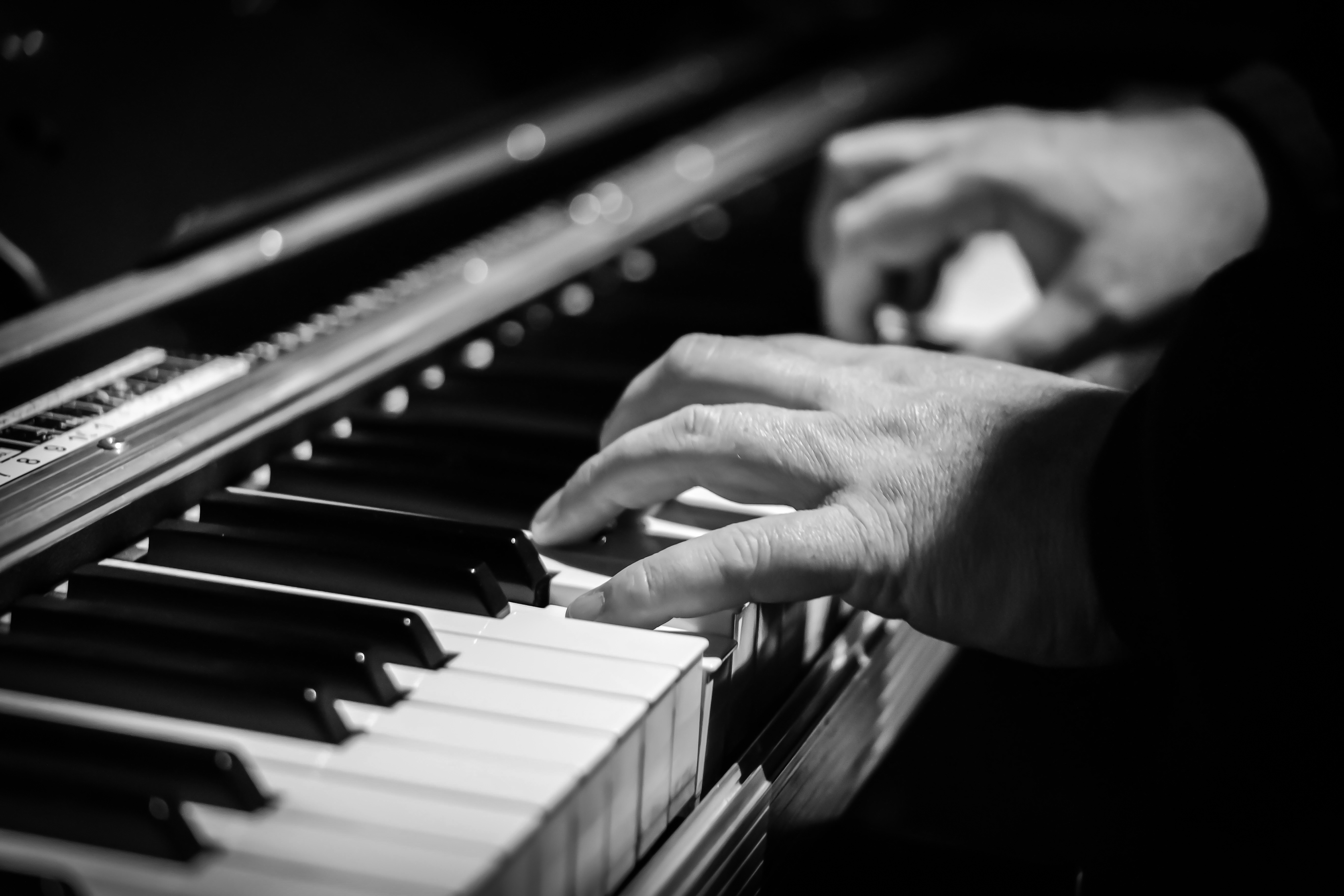 Black and white photo of a man playing the piano free image download