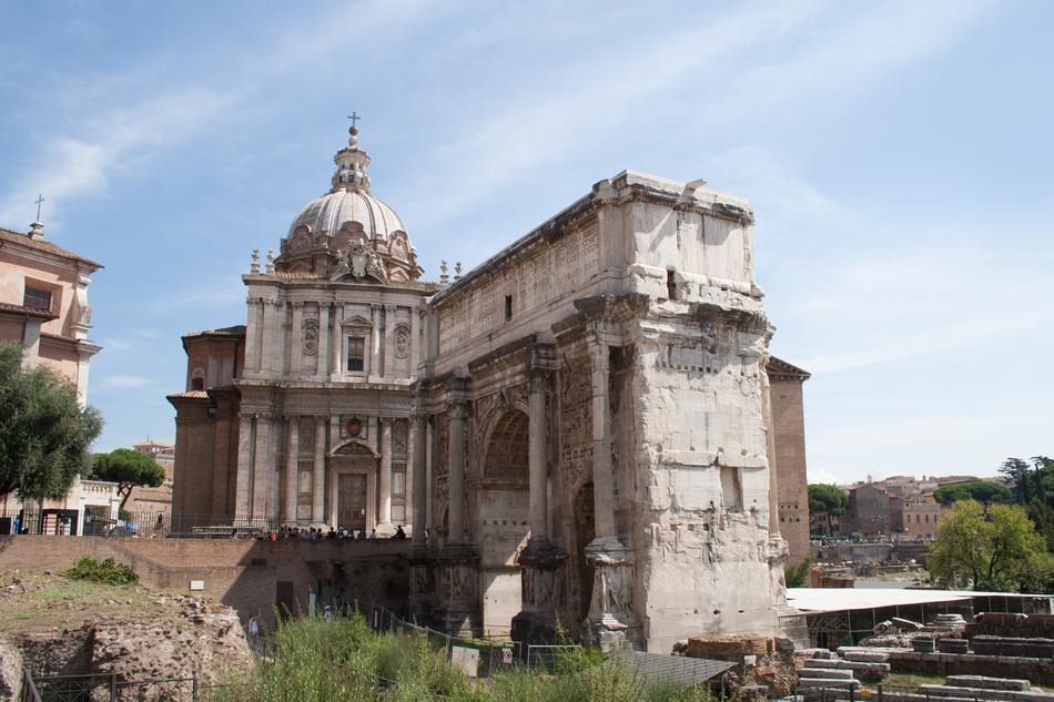 Beautiful Roman Forum, with the columns, among the colorful plants, in