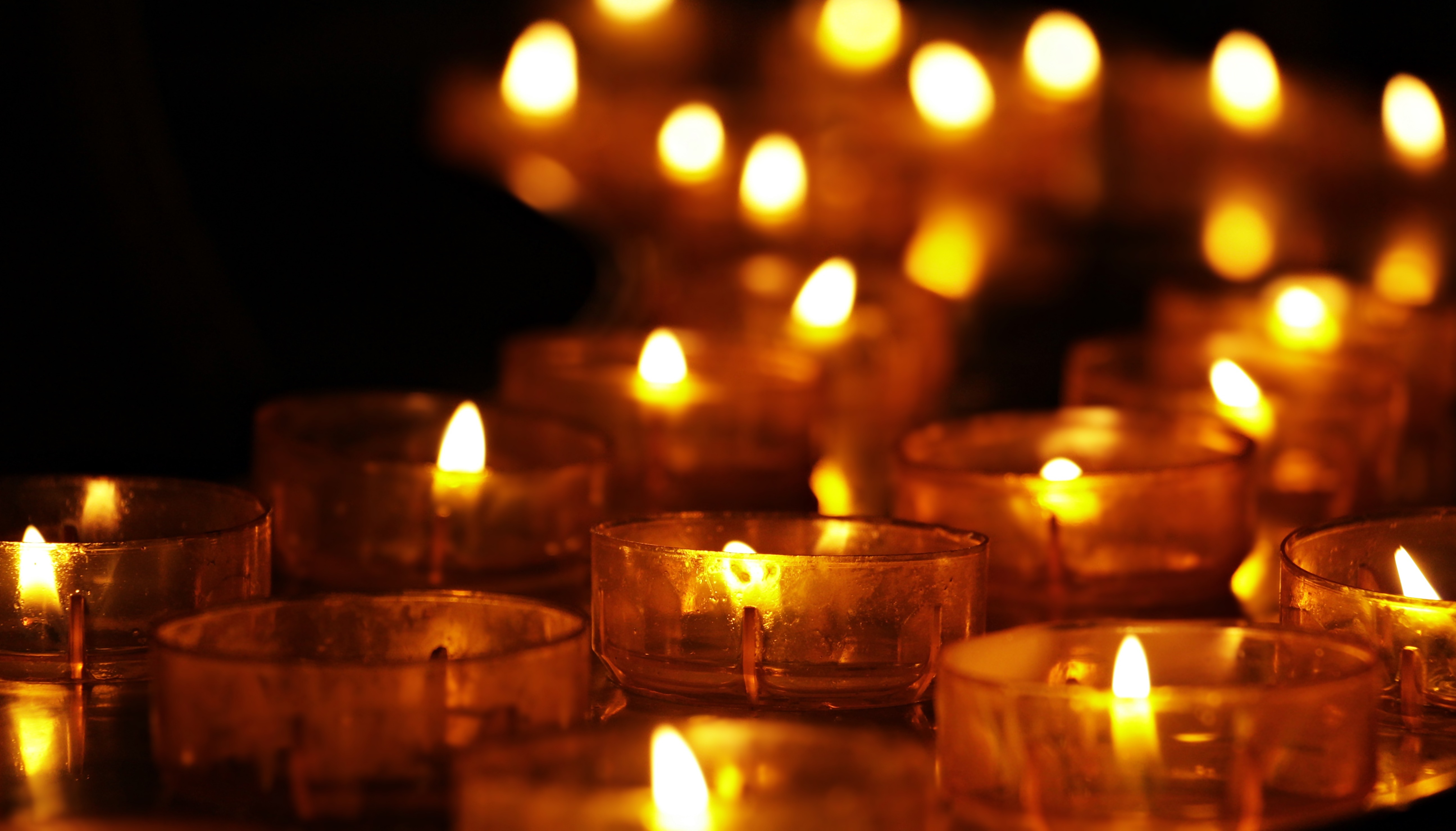 Burning yellow candles in the dark free image download