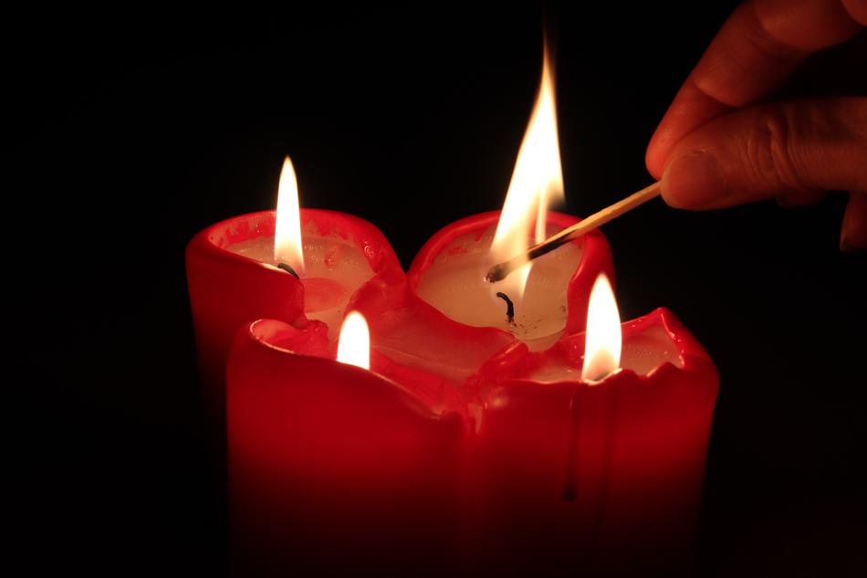 Person lighting candles free image download