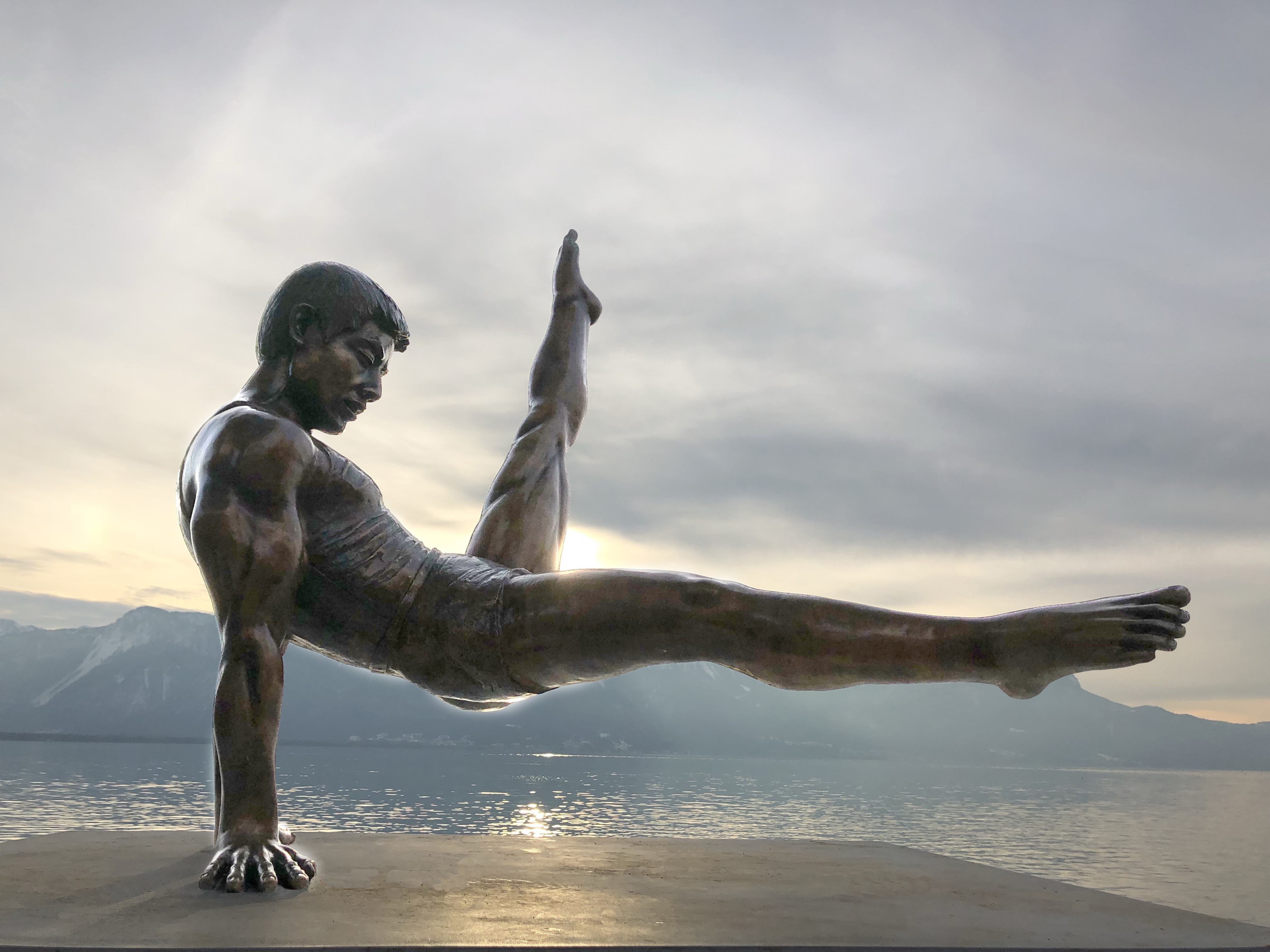 Beautiful, shiny statue of gymnast, on the shore in Montreux