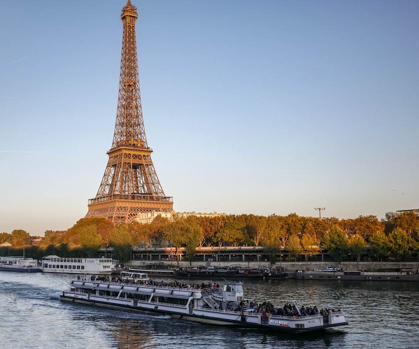 Boat on the beautiful Seine river near the coast with colorful trees