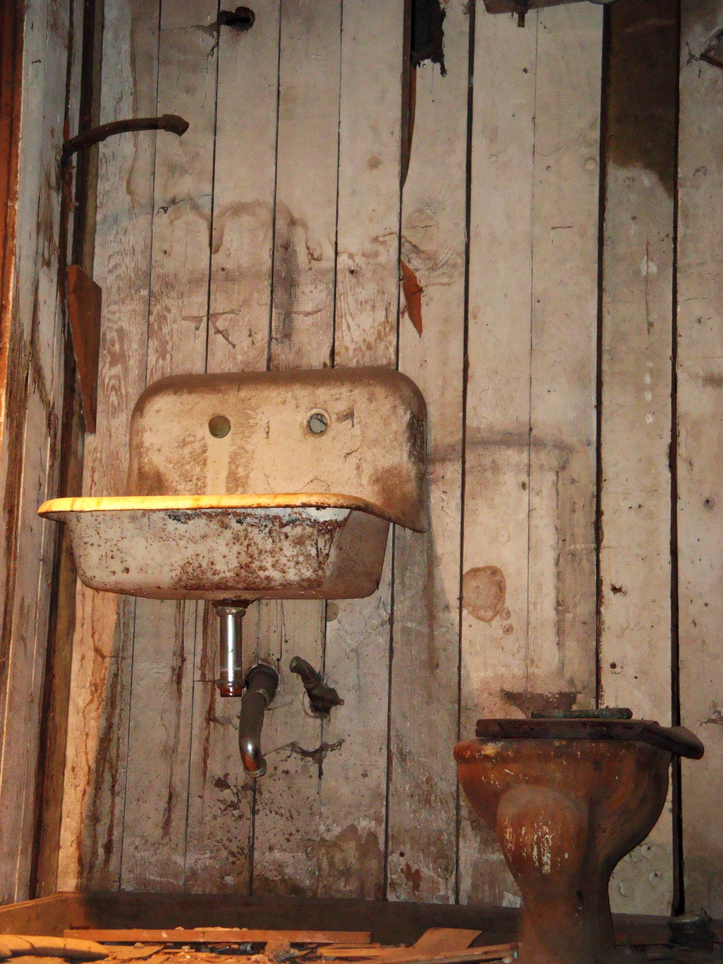 Grunge, old metal washbasin and toilet bowl in the bathroom free image