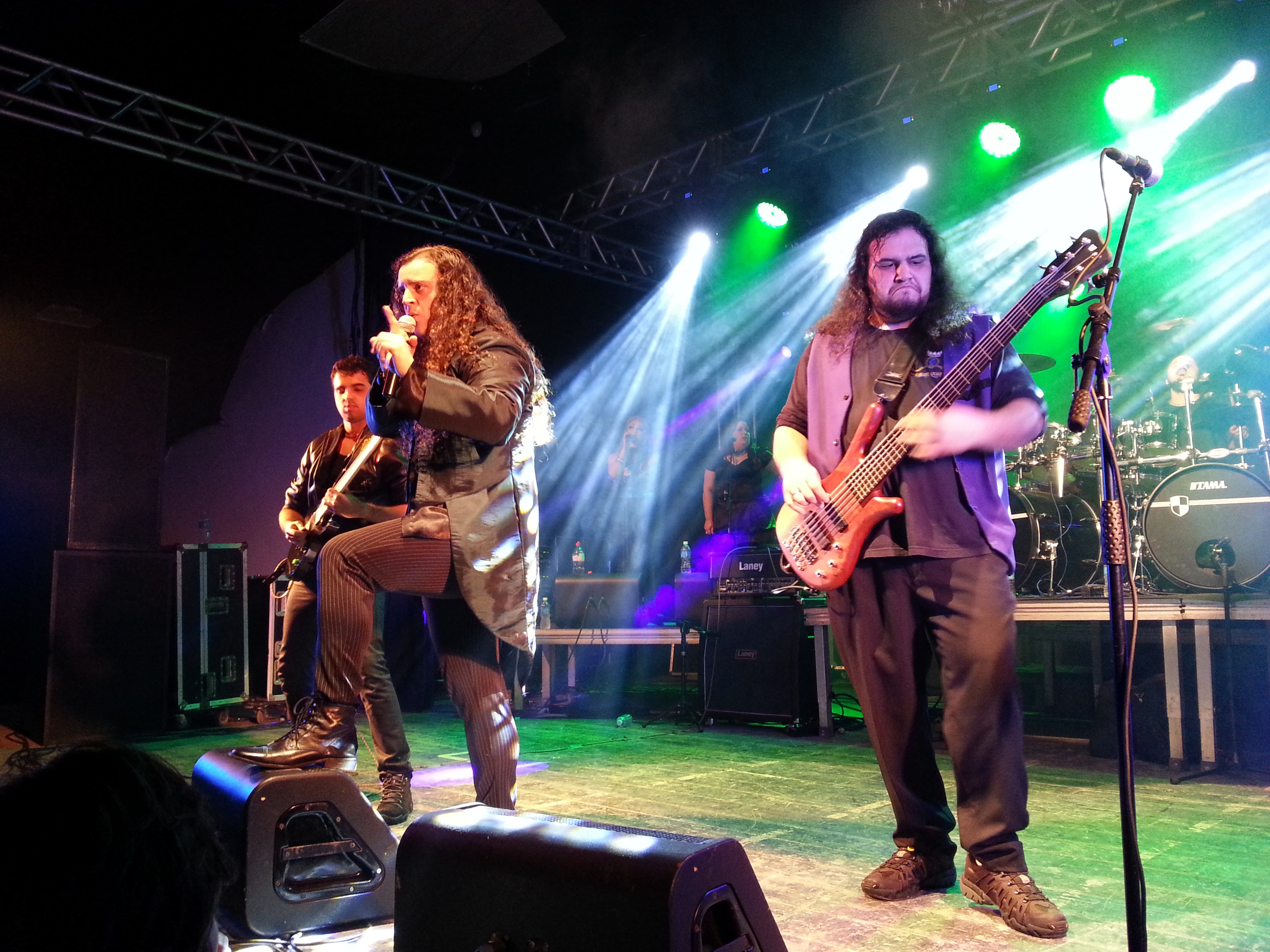 Long haired rock musicians on stage with bright lights free image download