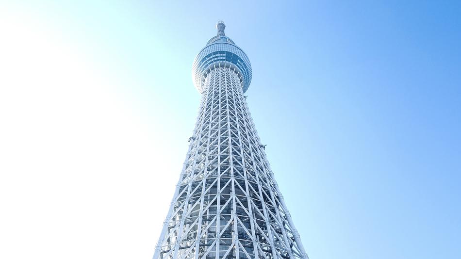 Low angle shot of the tower in Japan, under the blue sky with sunlight