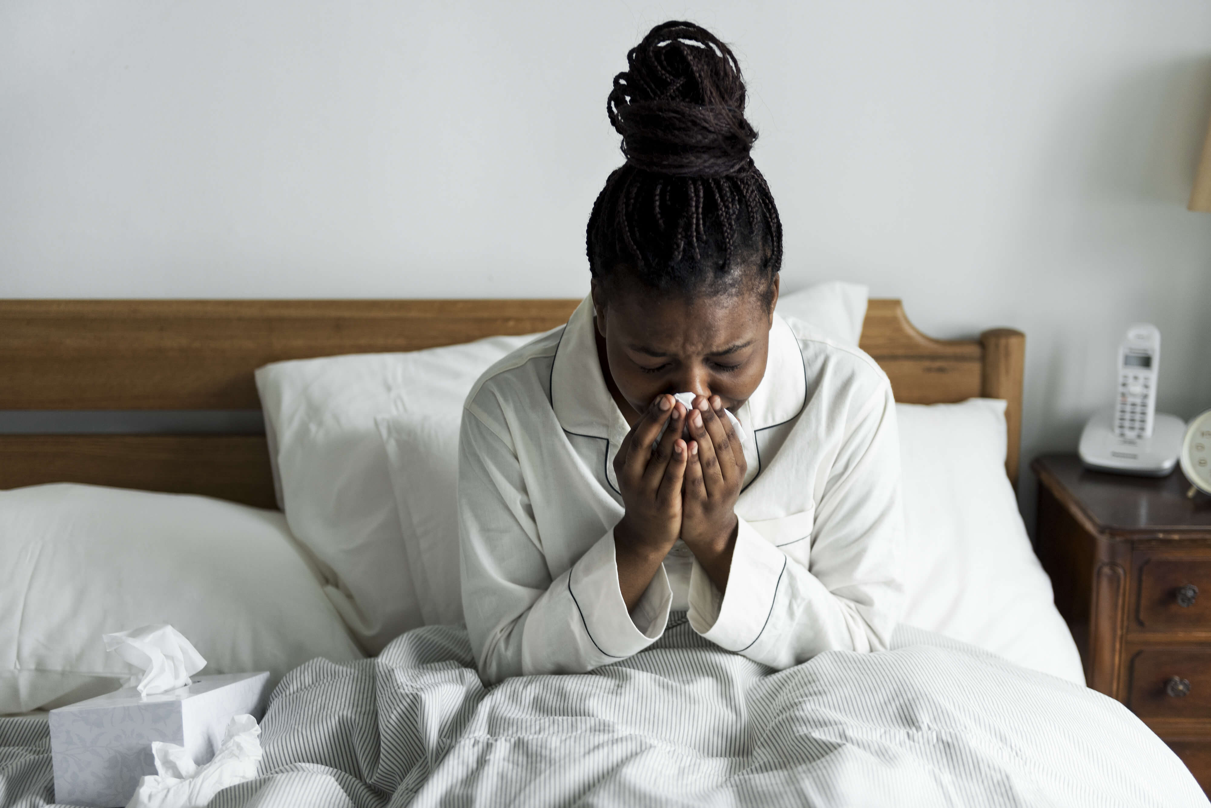 A sick woman in bed Platte River Medical Clinic