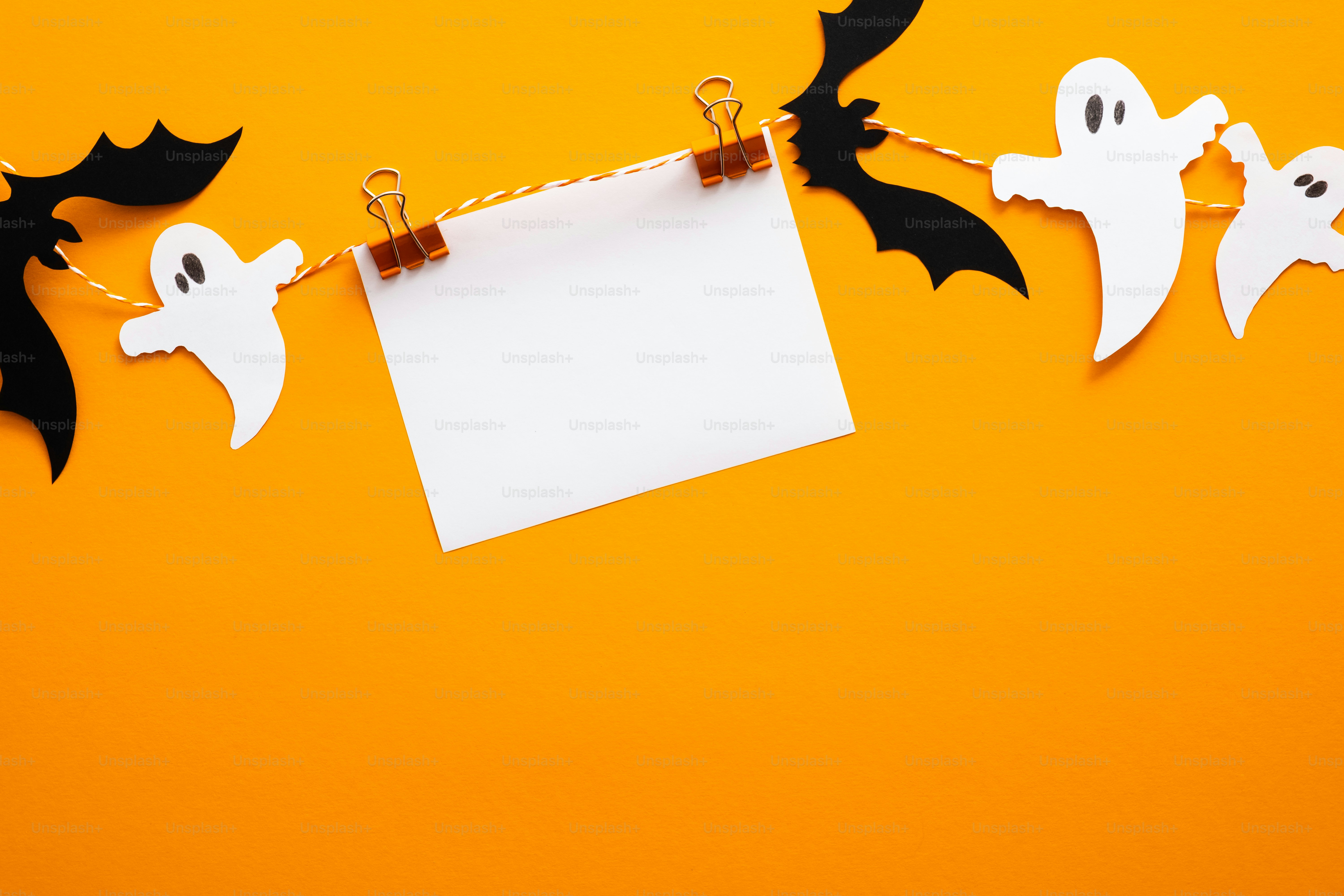Halloween holiday concept. Halloween bats on orange background