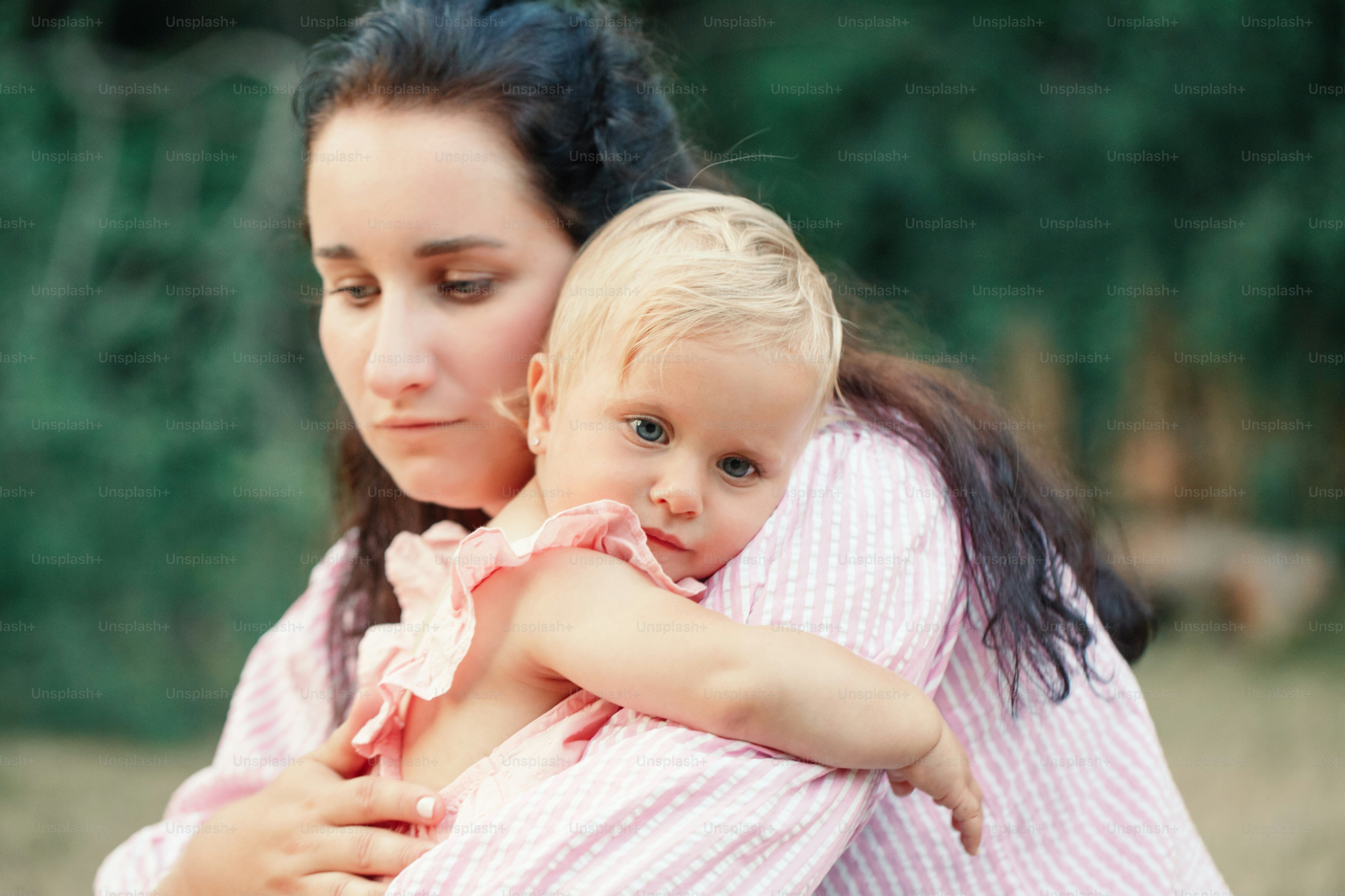 Mother hugging pacifying sad upset toddler girl. Family young mom and