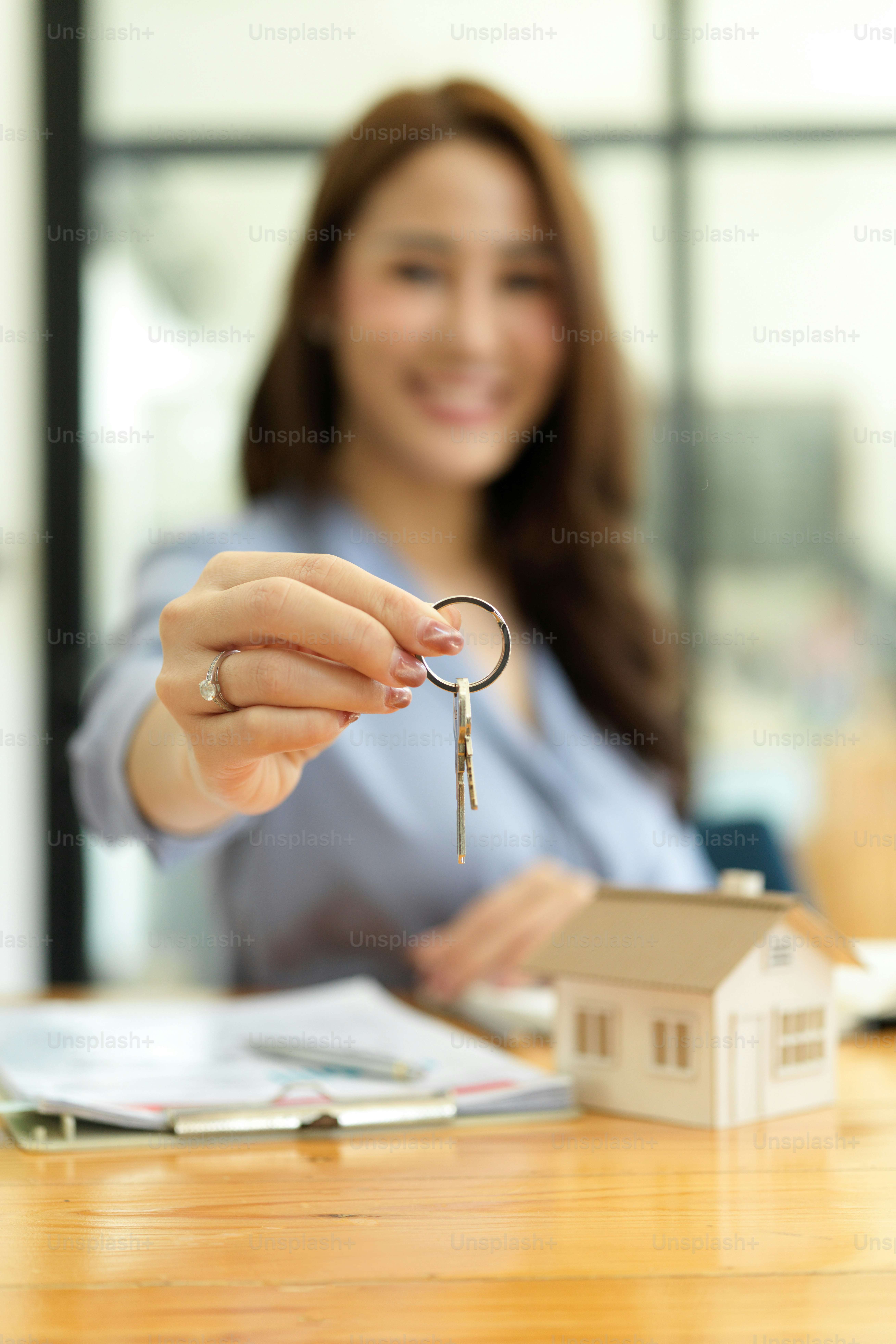 Focused hands, Beautiful real estate agent holding house key, house