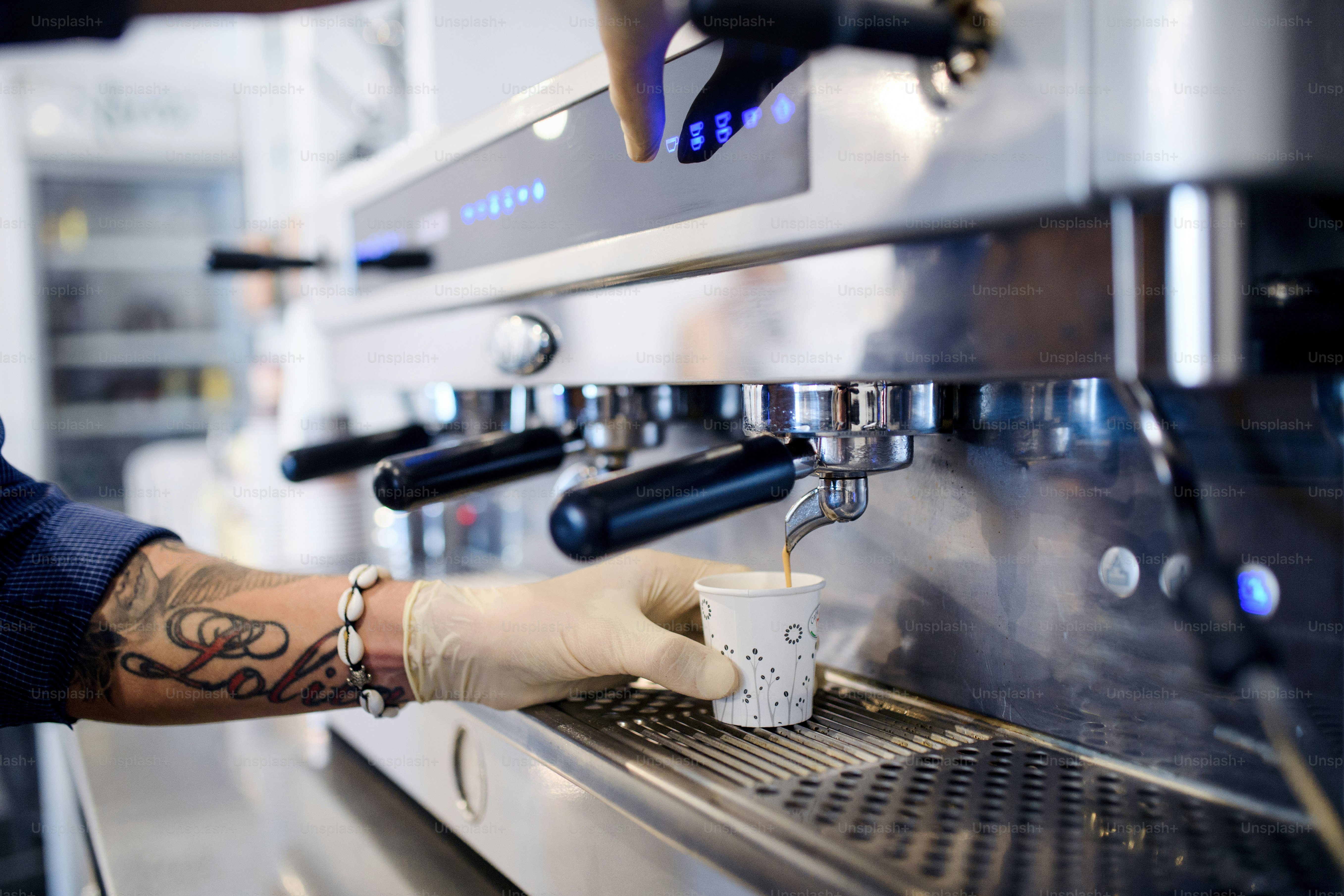Unrecognizable barista working with gloves, coffee shop open after