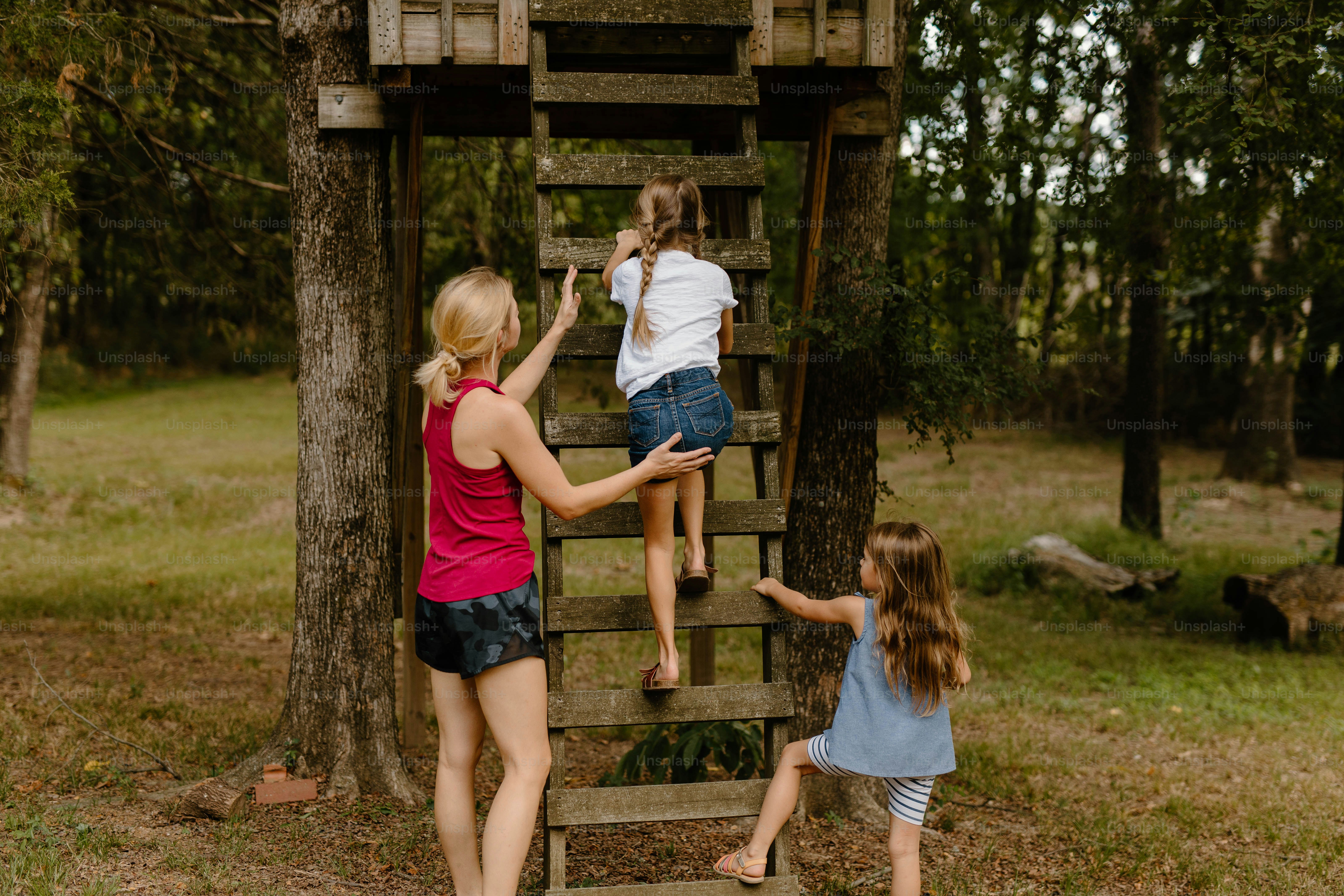 A group of girls climbing up a wooden ladder photo Nanny Image on