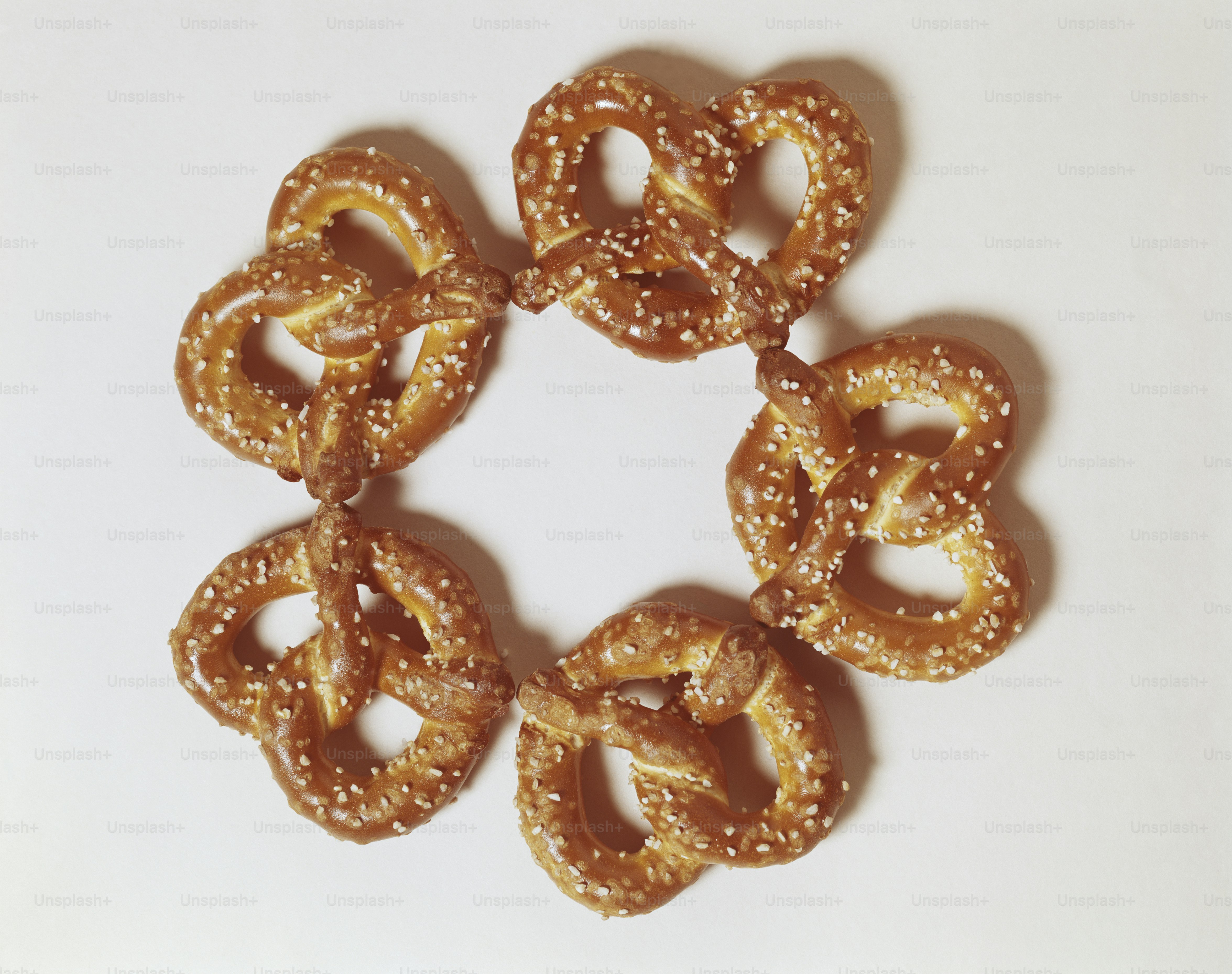 Six pretzels arranged in a circle on a white surface photo Pretzel