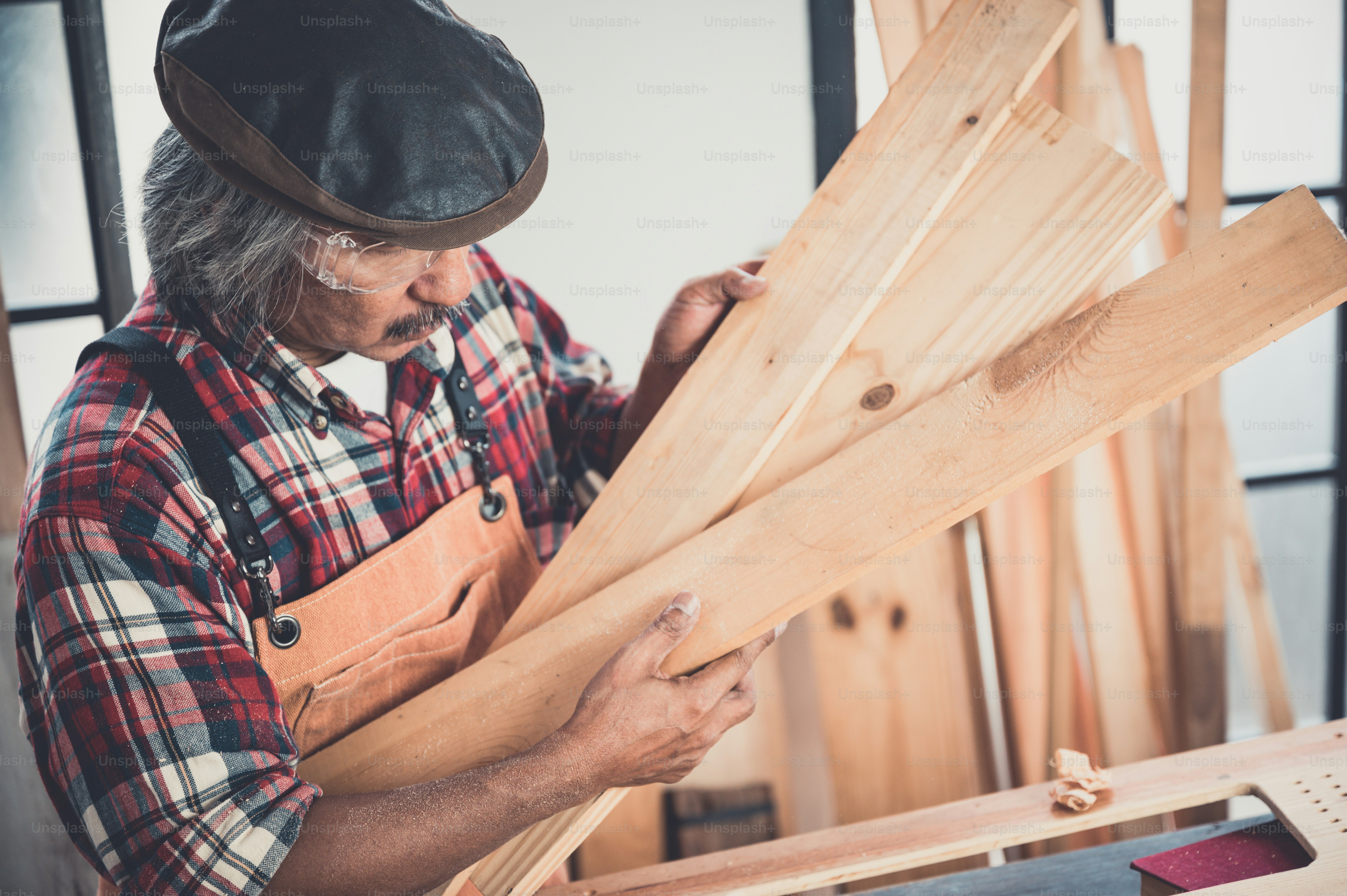 Man doing woodwork in carpentry. Carpenter work on wood plank in