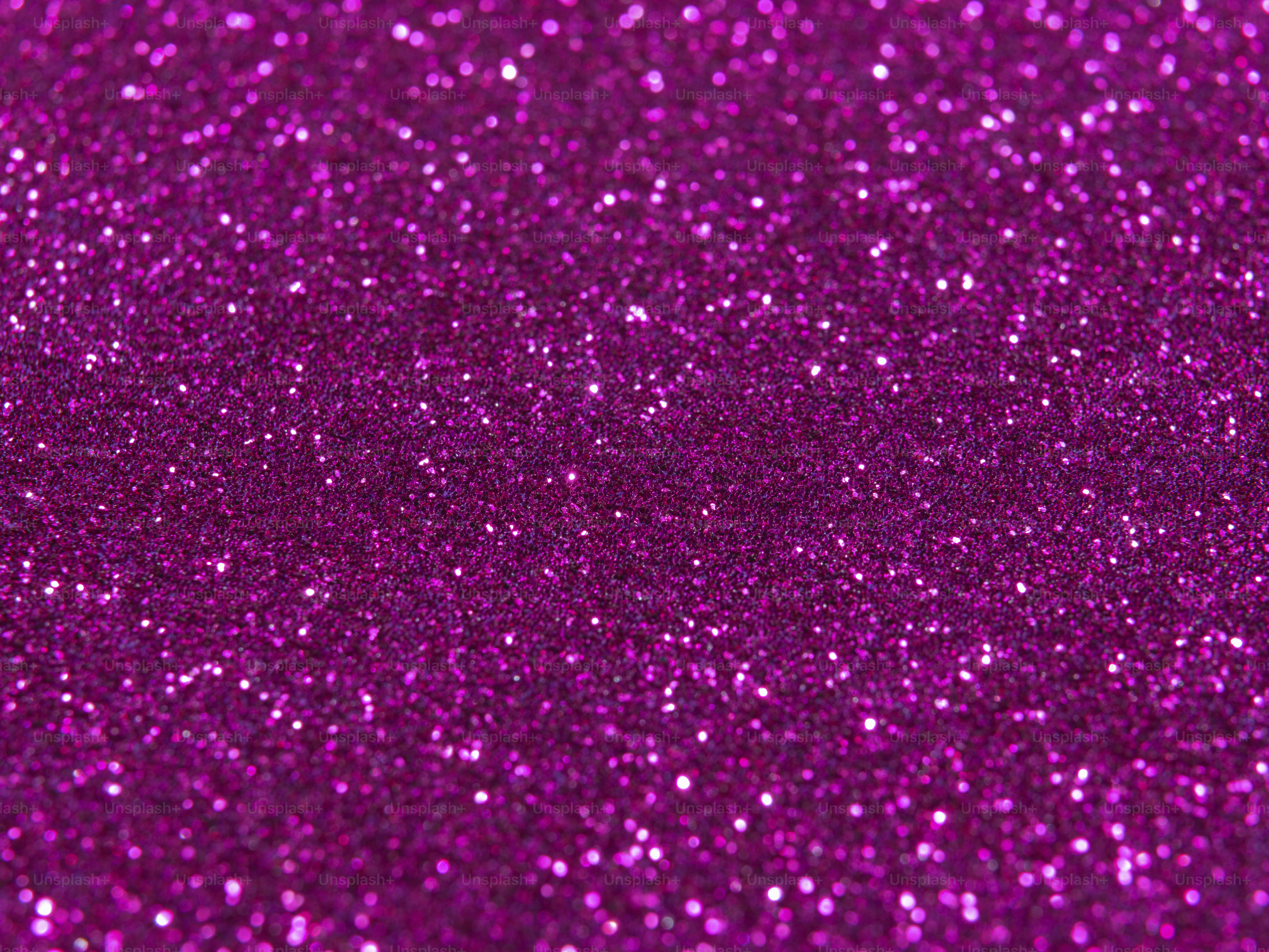 A bright pink glitter background with lots of sparkle photo Purple