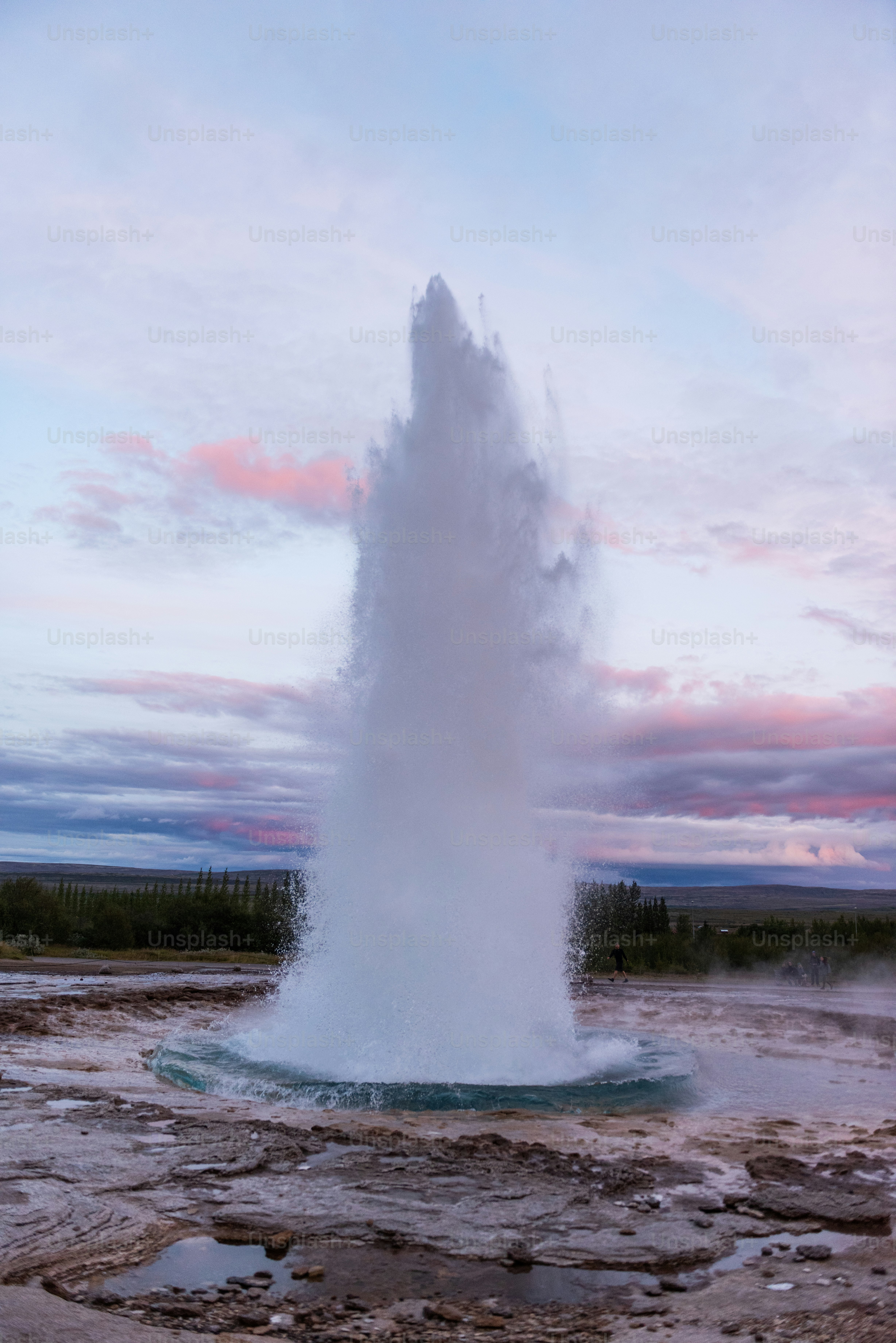A geyser spewing water into the air photo Geyser Image on Unsplash