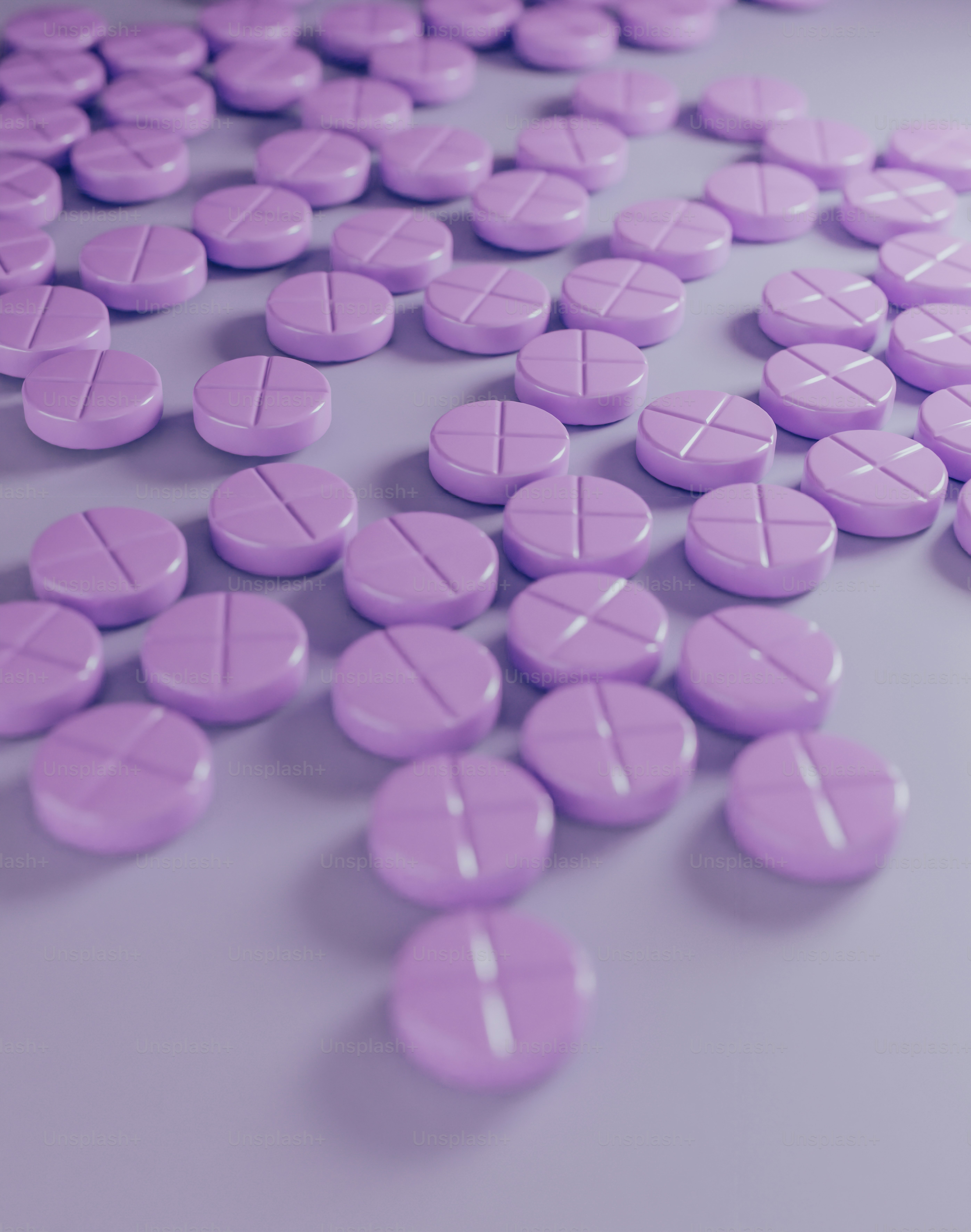 A group of purple pills sitting on top of a table photo Medication