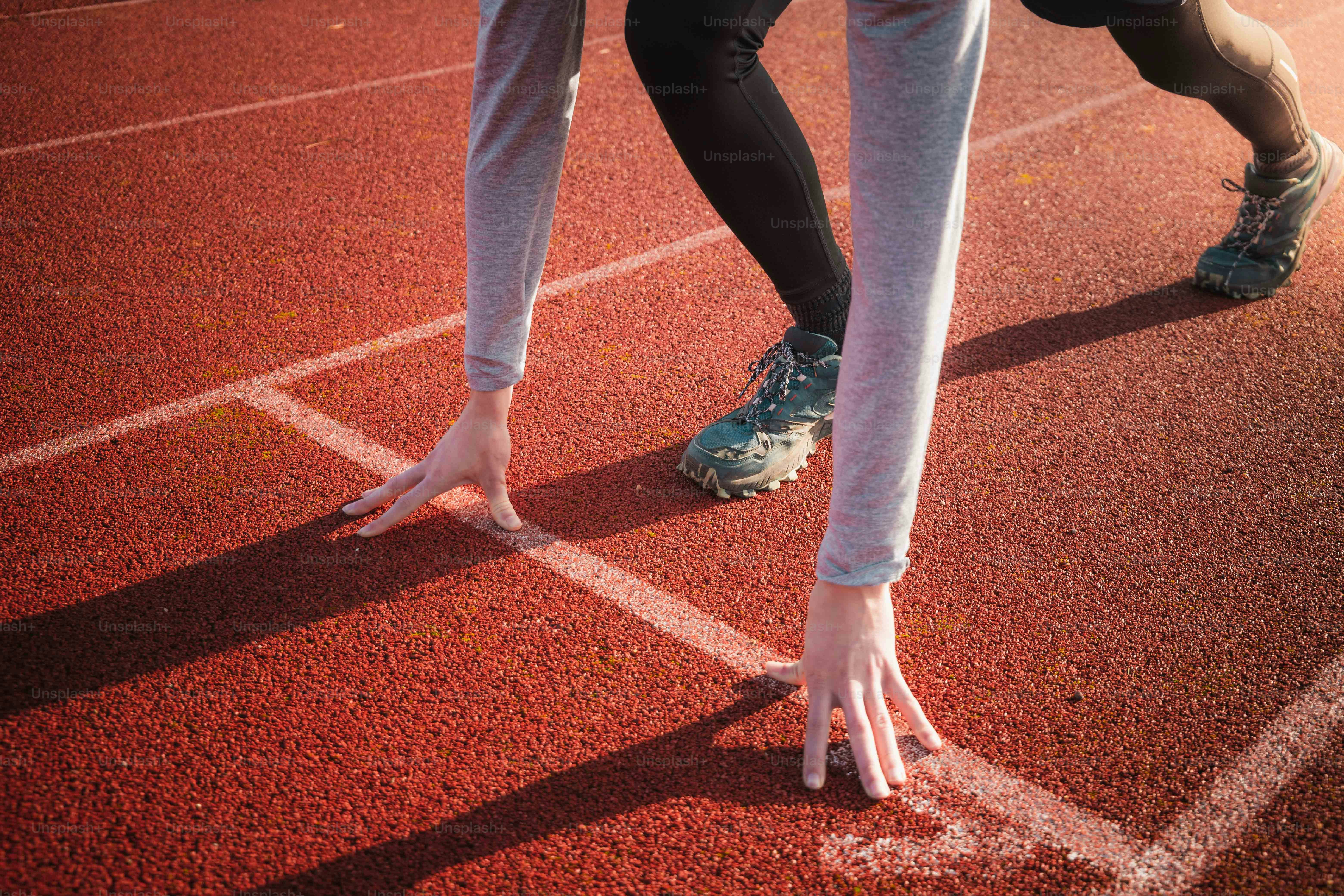 A close up of a person's feet on a running track photo Run Image on